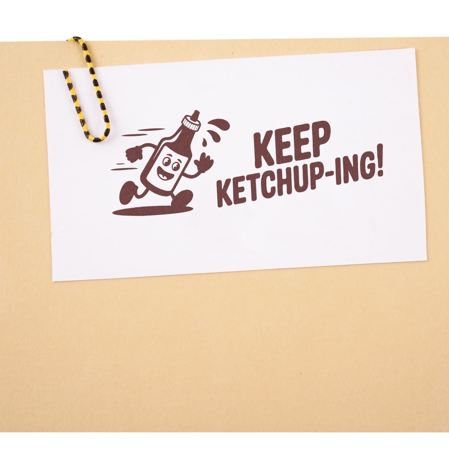Custom rubber stamp with fun ketchup pun, Keep Ketchup-ing!, featuring a smiling ketchup bottle design.
