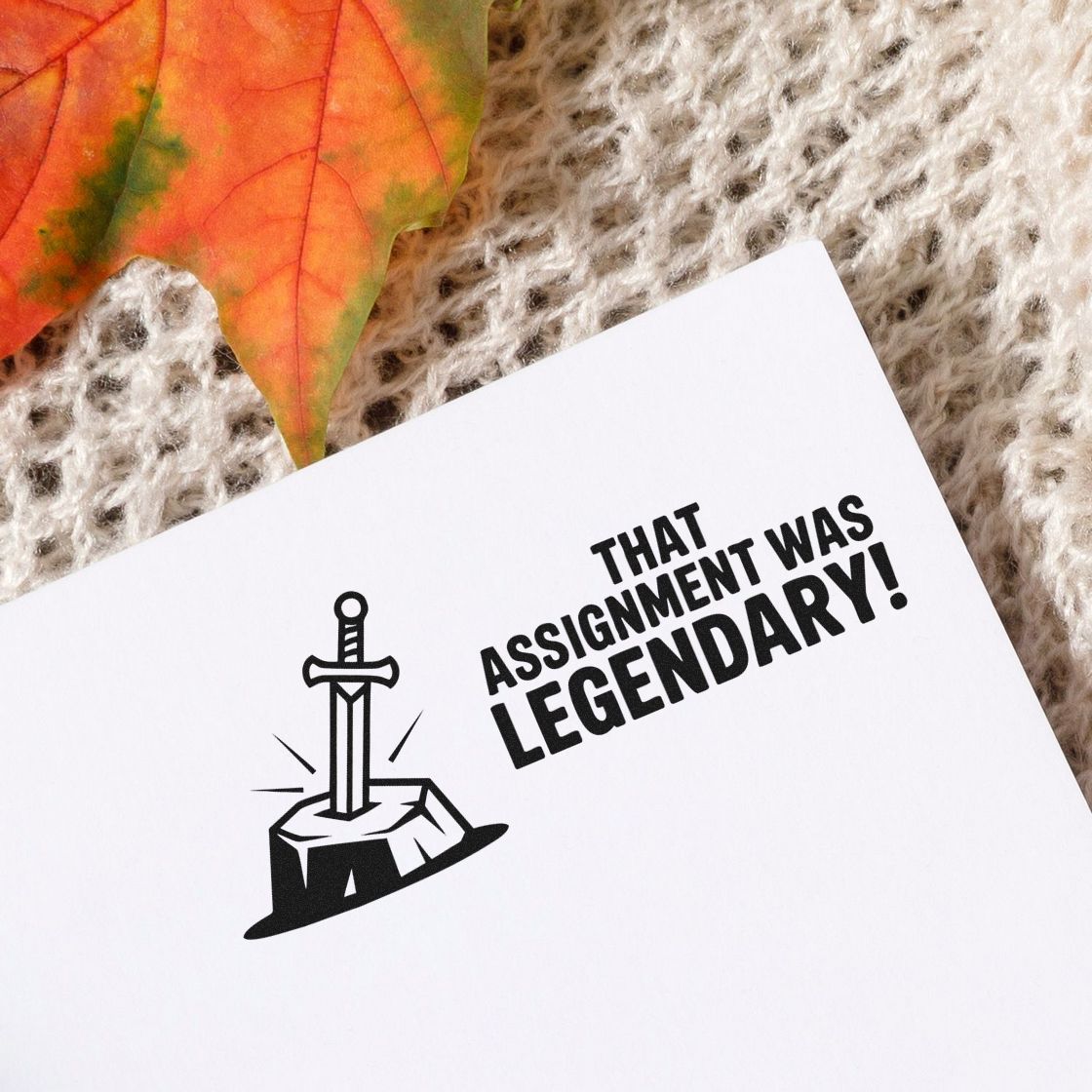 Funny rubber stamp design with sword-in-stone icon and bold text, That assignment was legendary!, for classroom rewards.