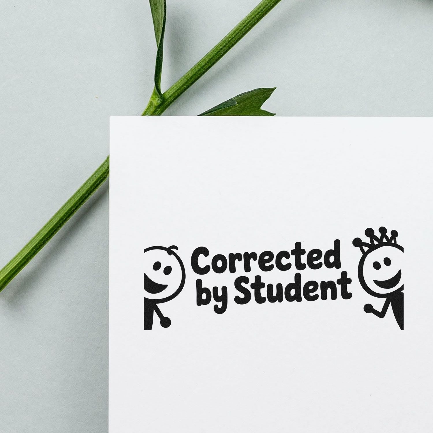 Custom rubber stamp reading Corrected by Student with playful stick figures, ideal for classroom grading and teacher feedback.