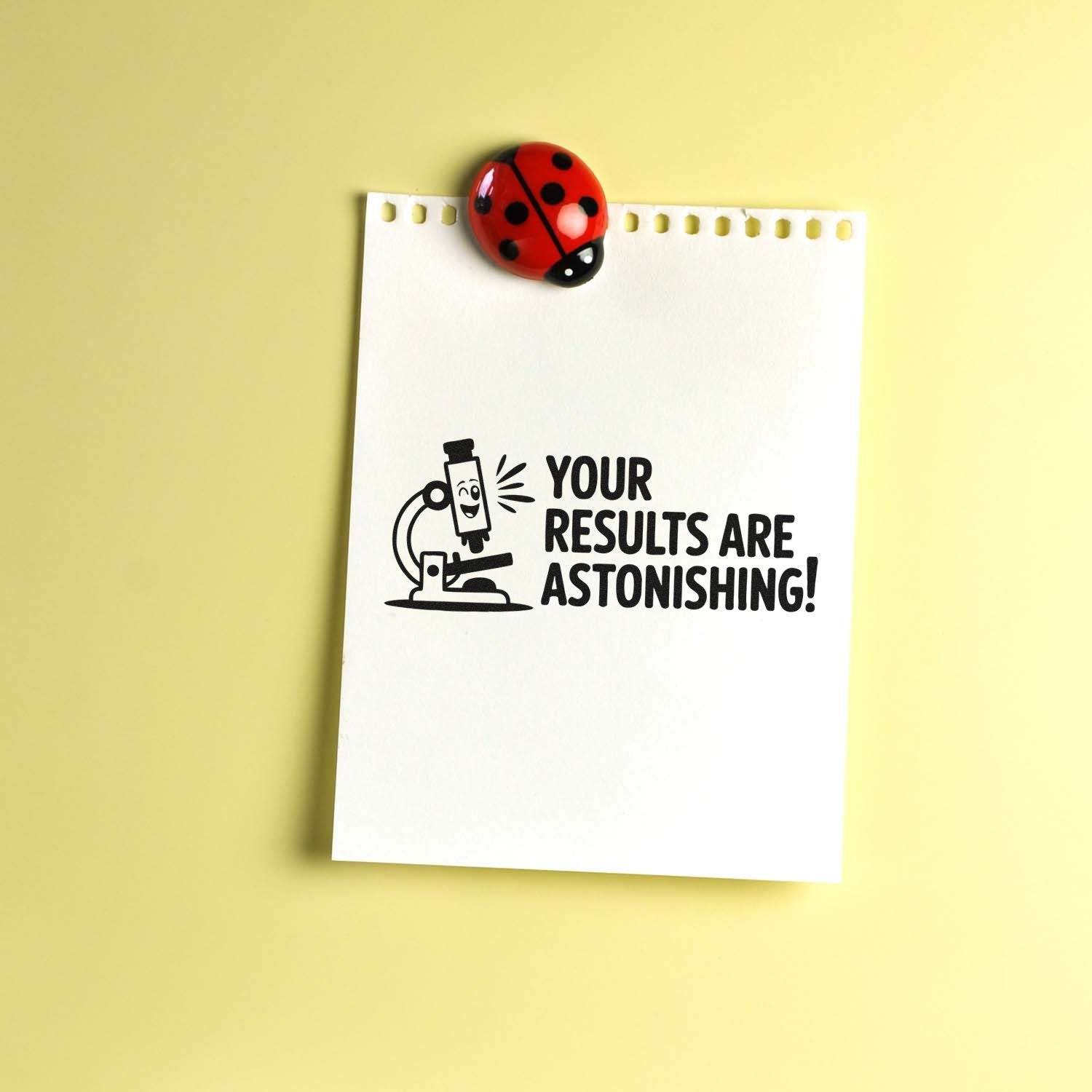 Science rubber stamp reading Your Results Are Astonishing! with microscope icon on paper, ideal for teacher grading.