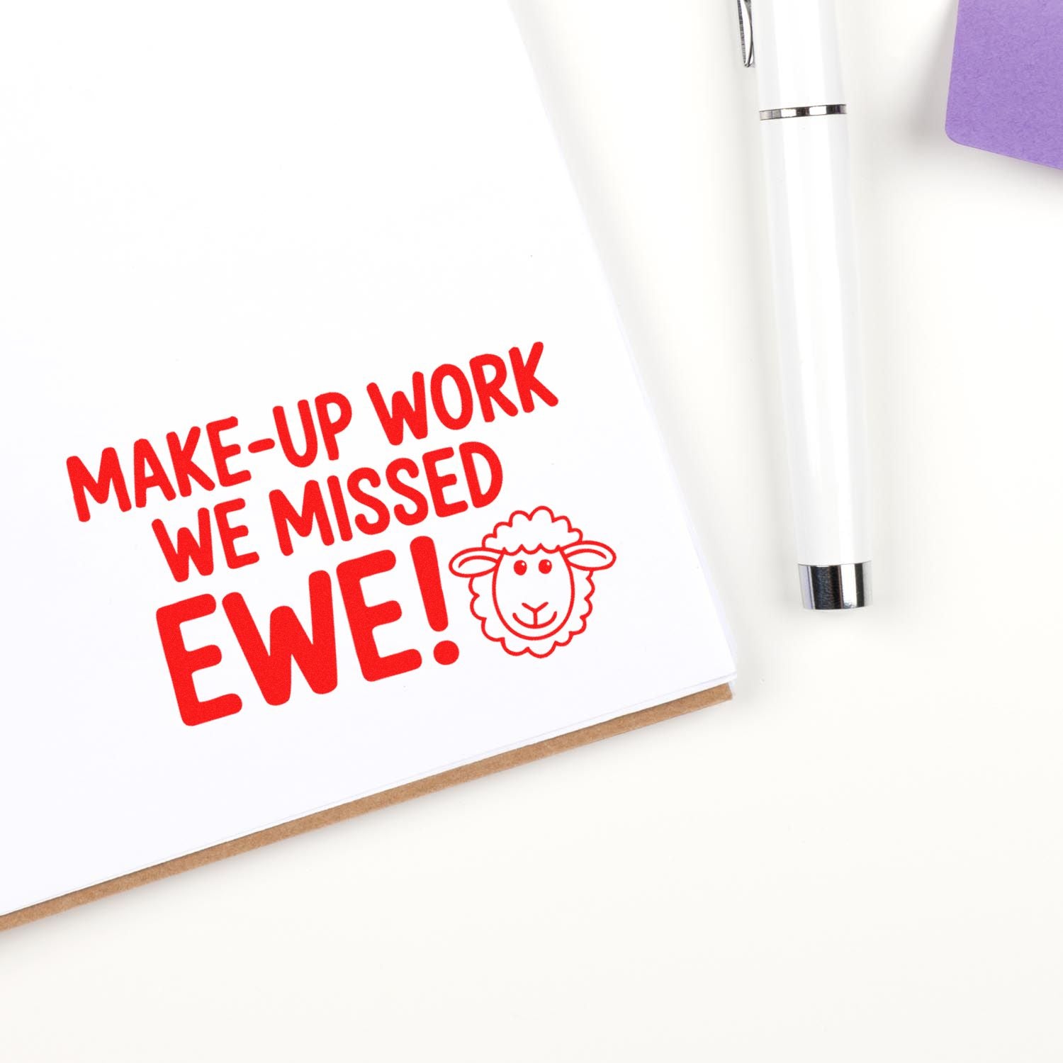 Teacher rubber stamp reading Make-up Work We Missed Ewe! for classroom makeup assignments, with sheep icon.