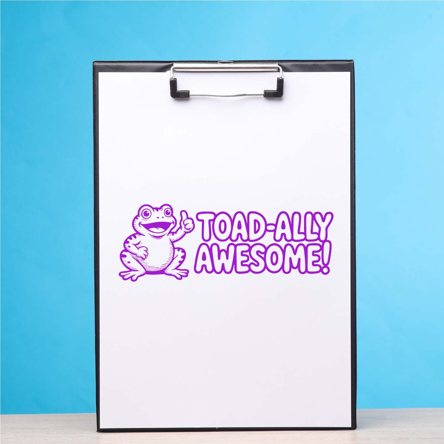 Purple frog rubber stamp reading TOAD-ALLY AWESOME! on a clipboard, fun motivational craft stamp design.