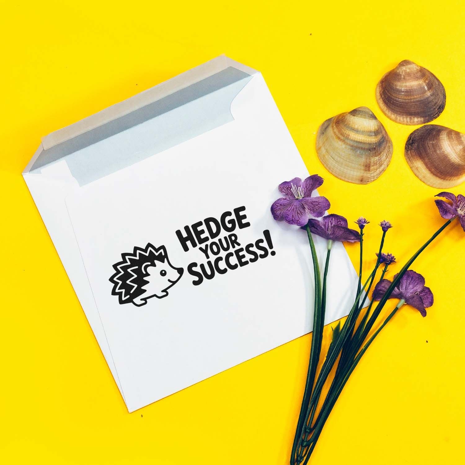 Hedge Your Success hedgehog rubber stamp on a white envelope, styled with purple flowers on a bright yellow background.