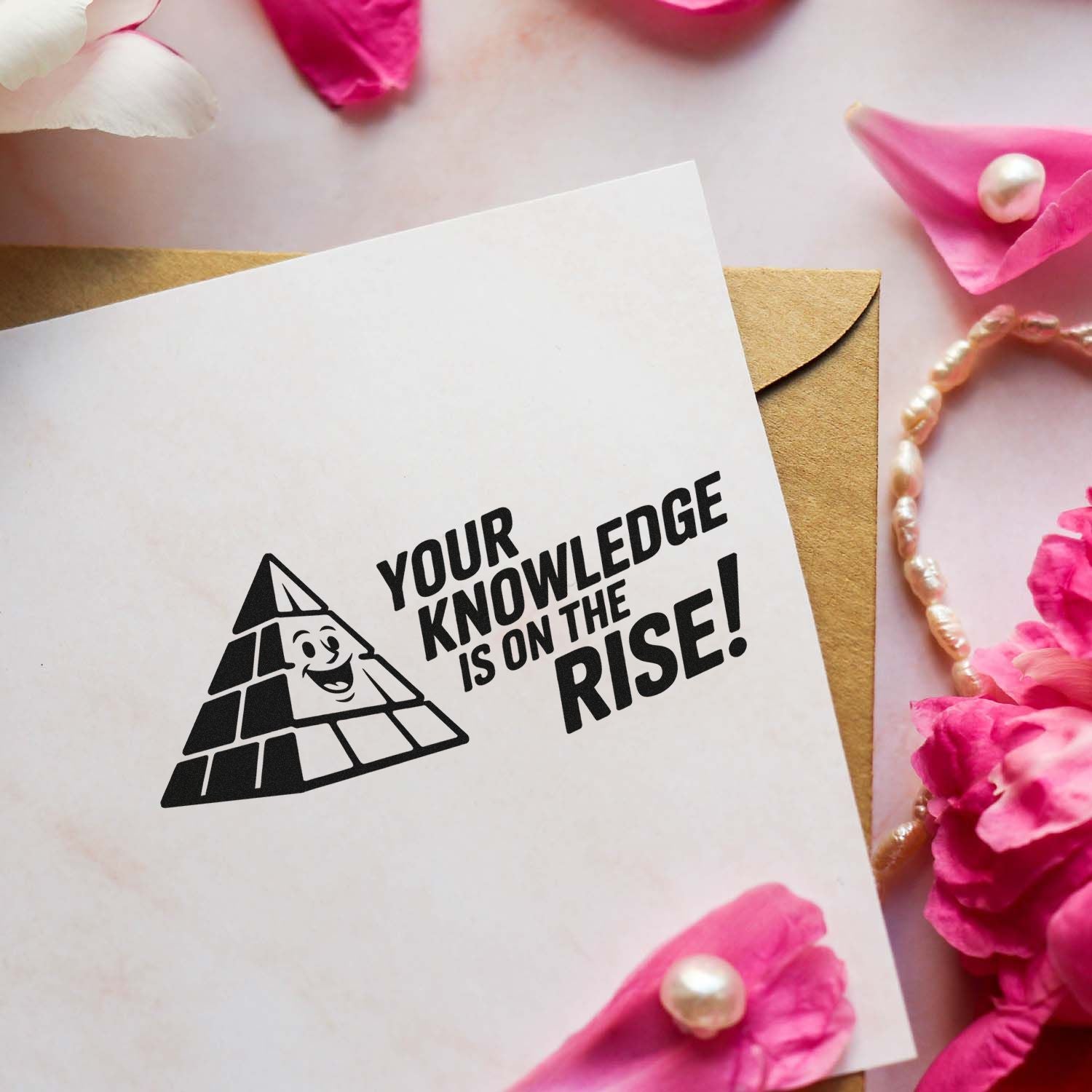 Custom rubber stamp on a greeting card with pyramid graphic and Your knowledge is on the rise! message.