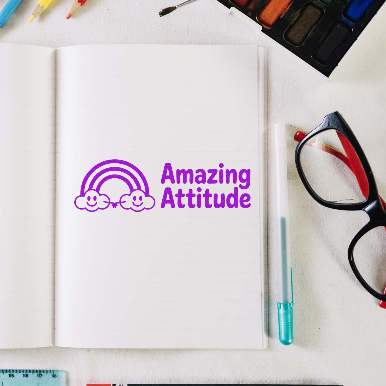 Amazing Attitude rubber stamp design on notebook, perfect for planners, crafts, and motivational stationery.