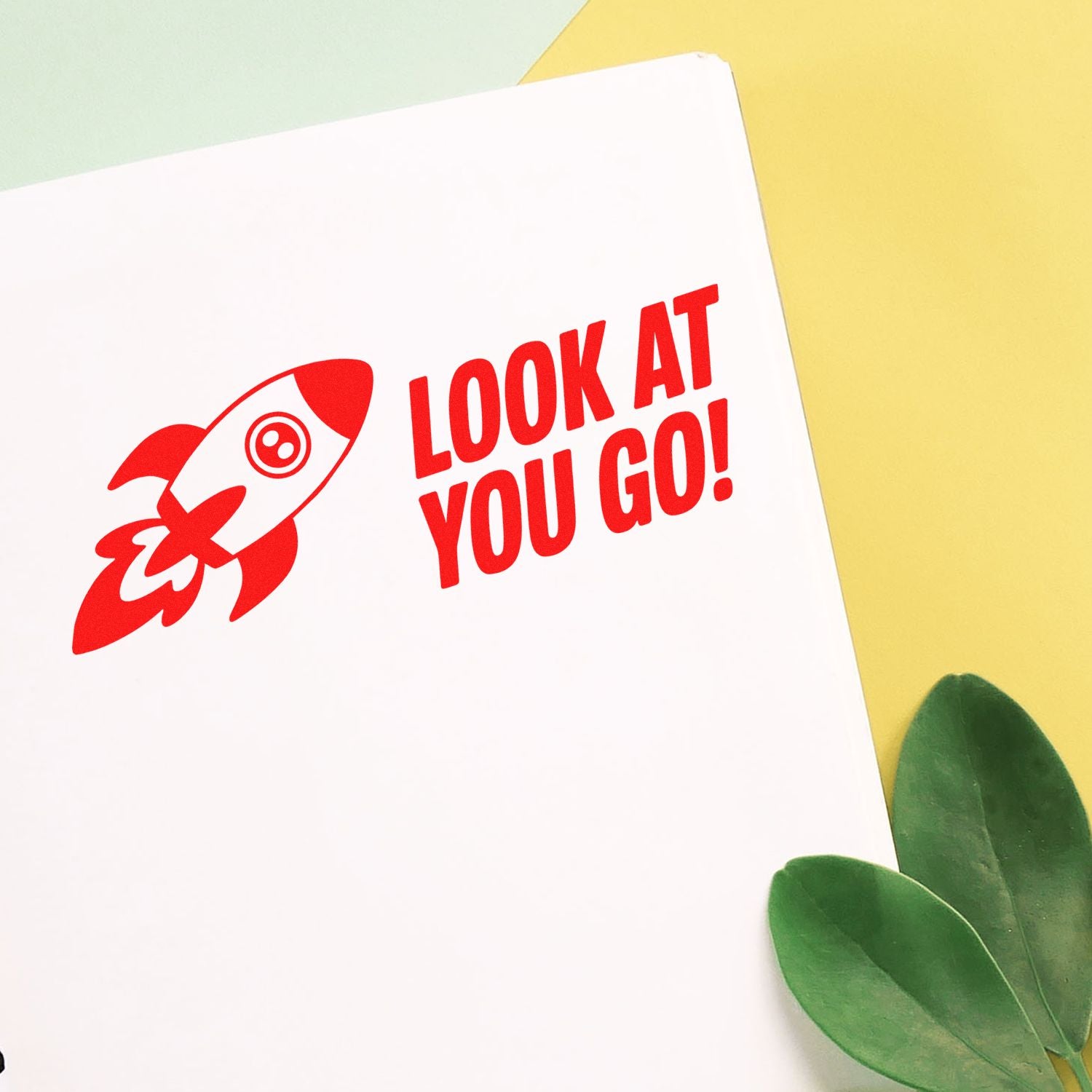 Motivational rubber stamp design with rocket and Look at You Go! text for encouraging cards, planners, and business packaging.
