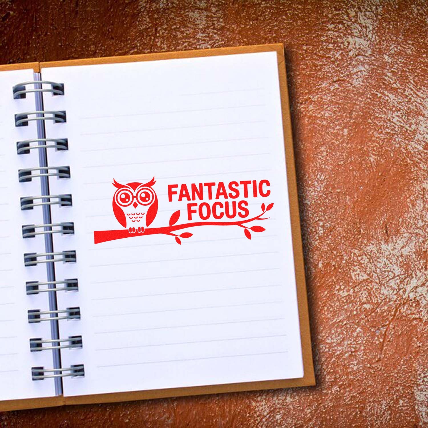 Red owl rubber stamp reading Fantastic Focus on notebook page, ideal for motivational teacher or office stamping.