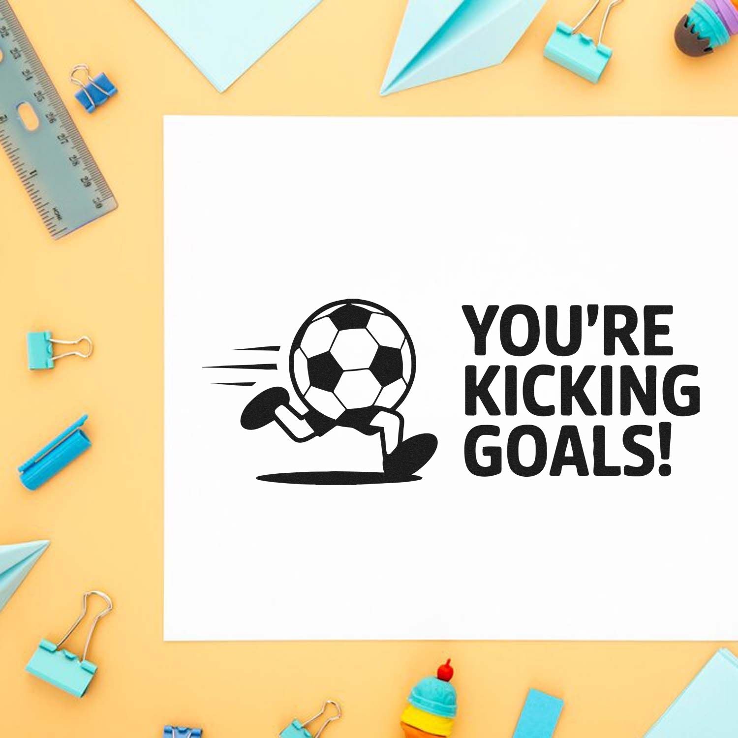 Soccer rubber stamp design with running ball and Youre Kicking Goals! text for sports-themed crafts and cards.