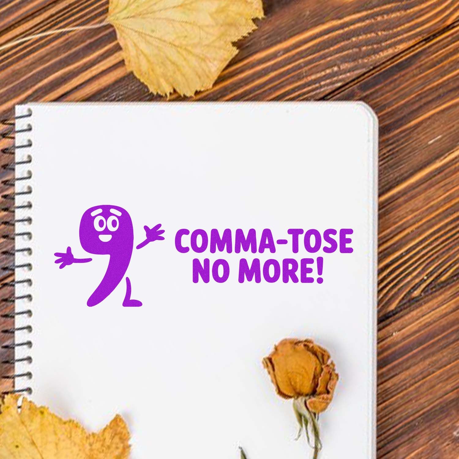 Funny Comma-Tose No More! rubber stamp design for grammar lovers, shown stamped on a notebook page.