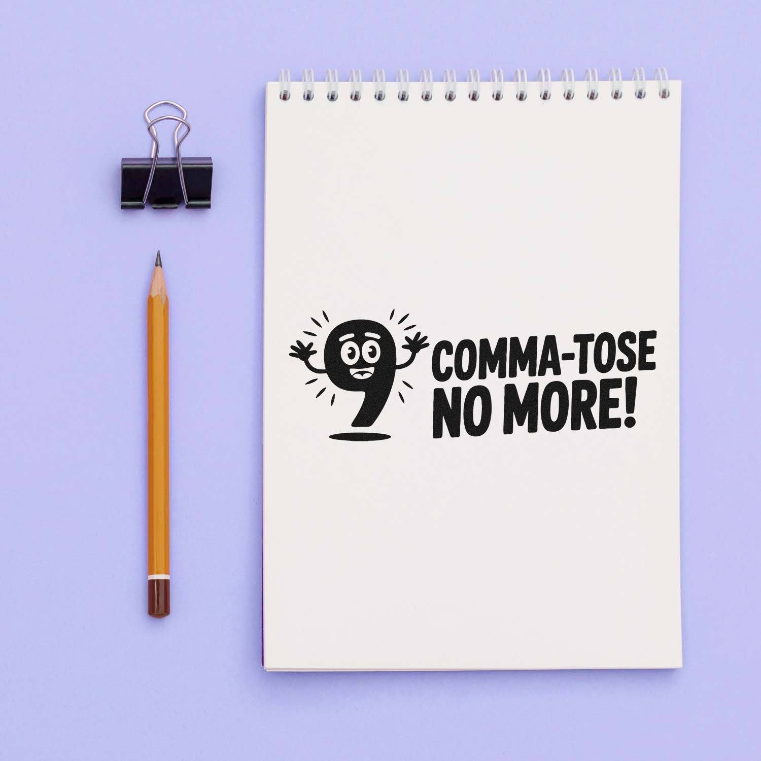 Custom rubber stamp impression on notebook reading Comma-tose No More! for writers, editors, and punctuation-themed stationery.