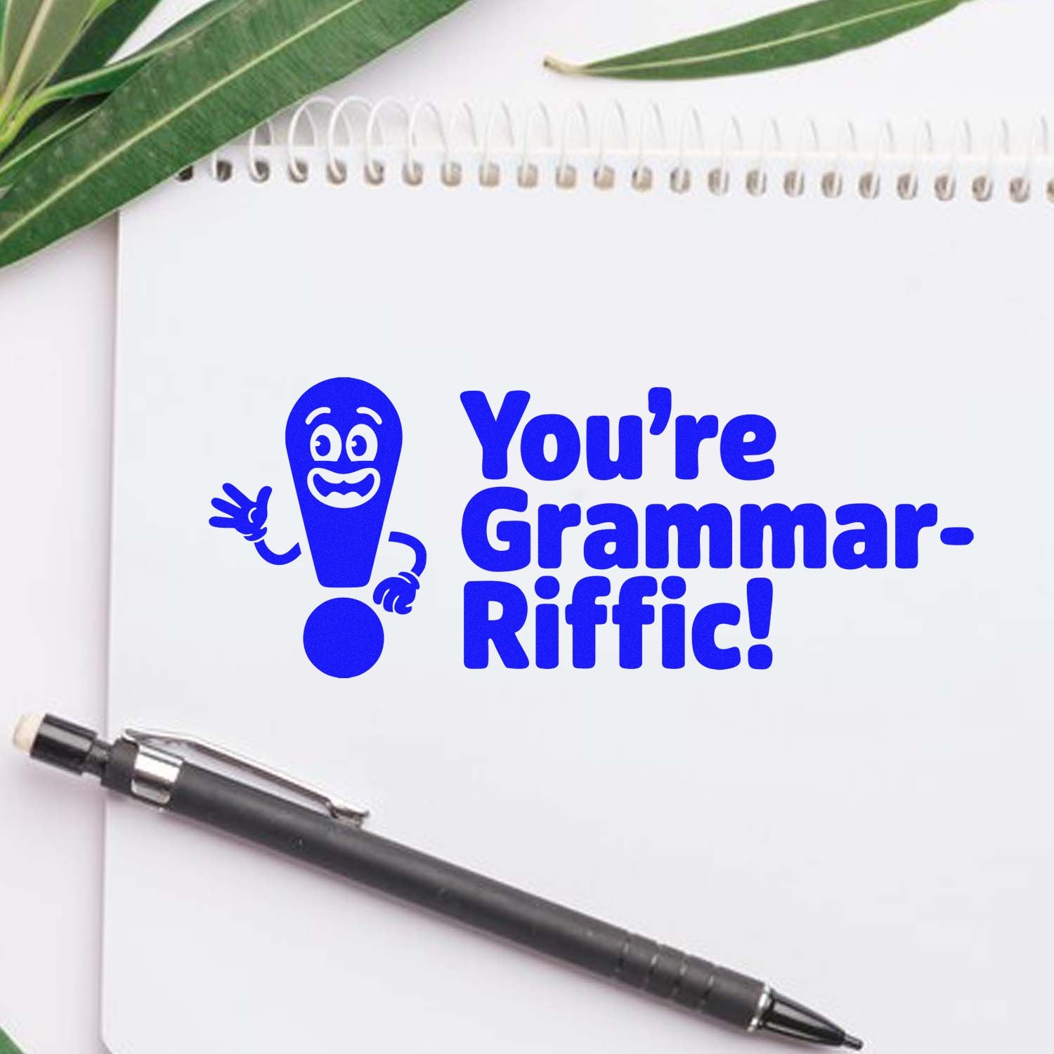 Youre Grammar-Riffic! rubber stamp design for teachers, featuring a playful blue grammar praise message on a notebook.