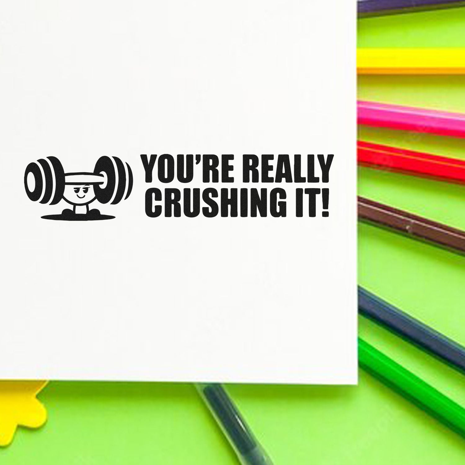 Motivational rubber stamp design with weightlifting cartoon and Youre Really Crushing It! text.