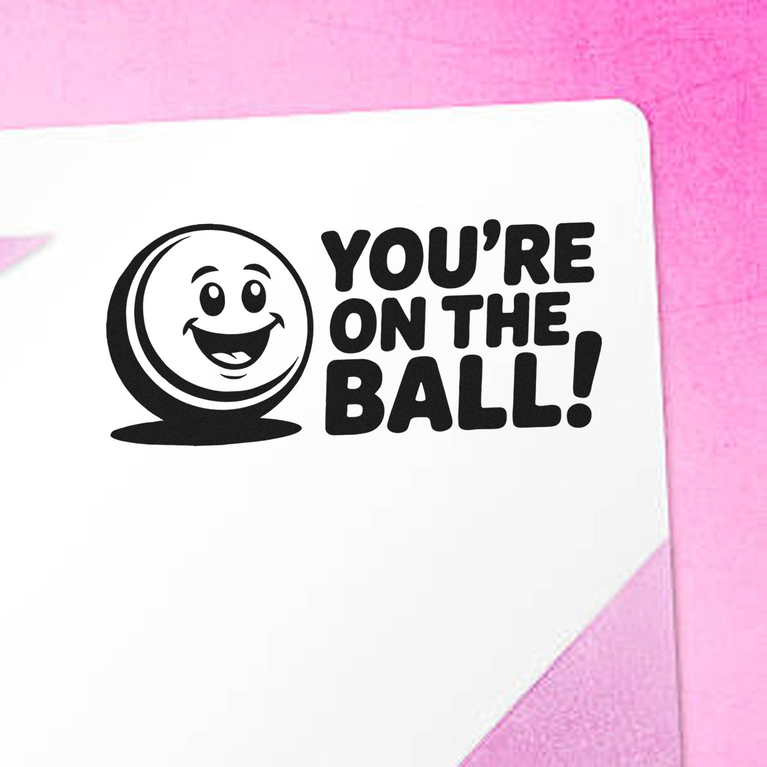 Rubber stamp design with smiling face and Youre on the Ball! message for fun motivational stationery.