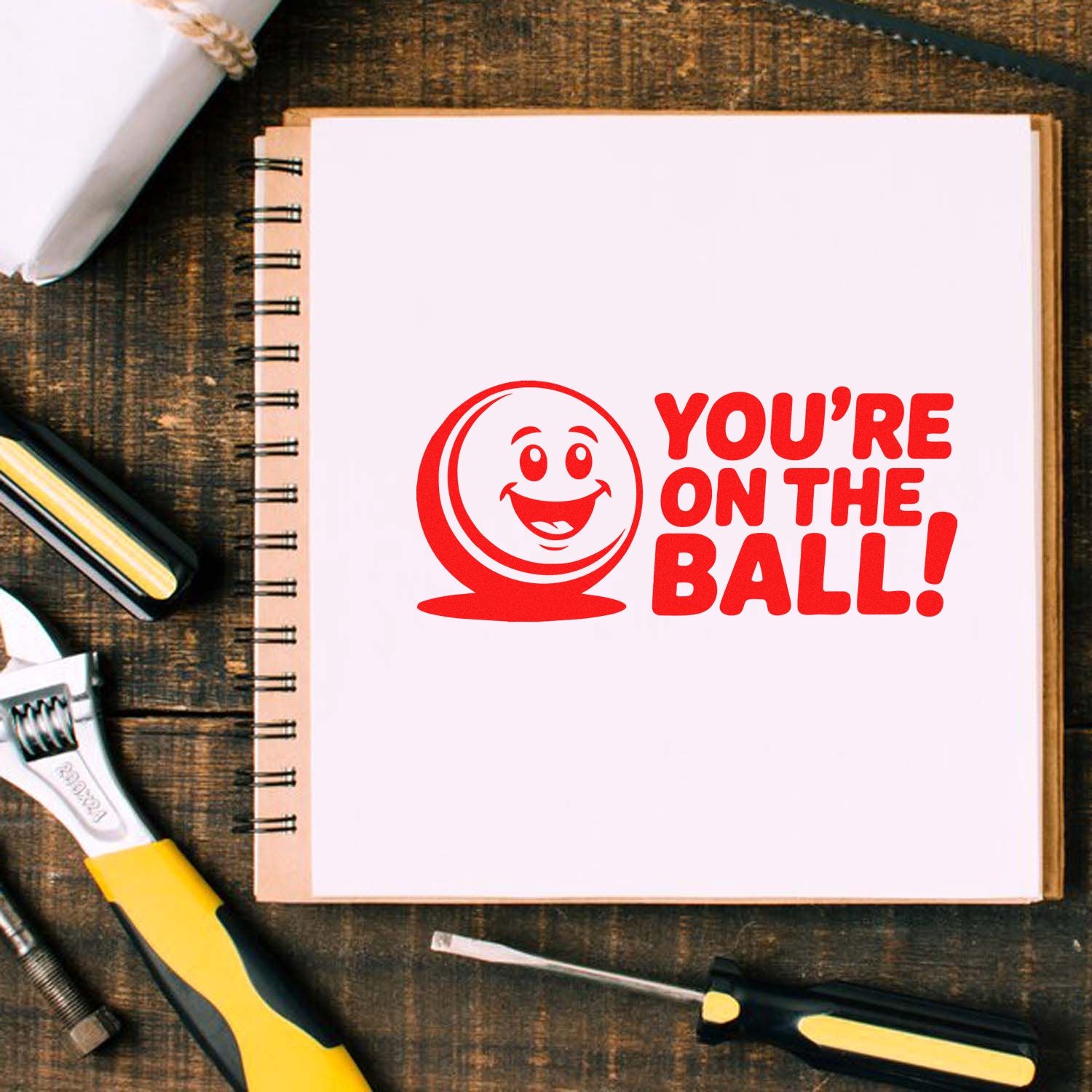 Youre on the Ball custom rubber stamp design with smiling ball logo, perfect for office, school, or teacher use.