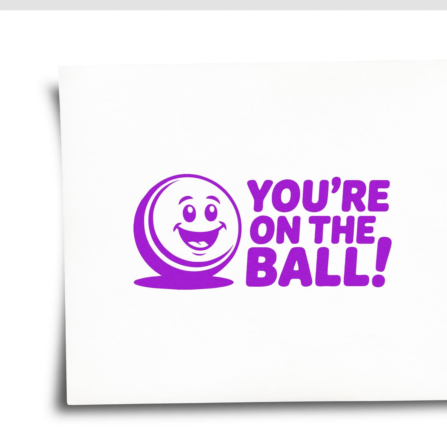 Purple rubber stamp design with smiling ball and Youre on the Ball! text for encouragement, office, or classroom use.