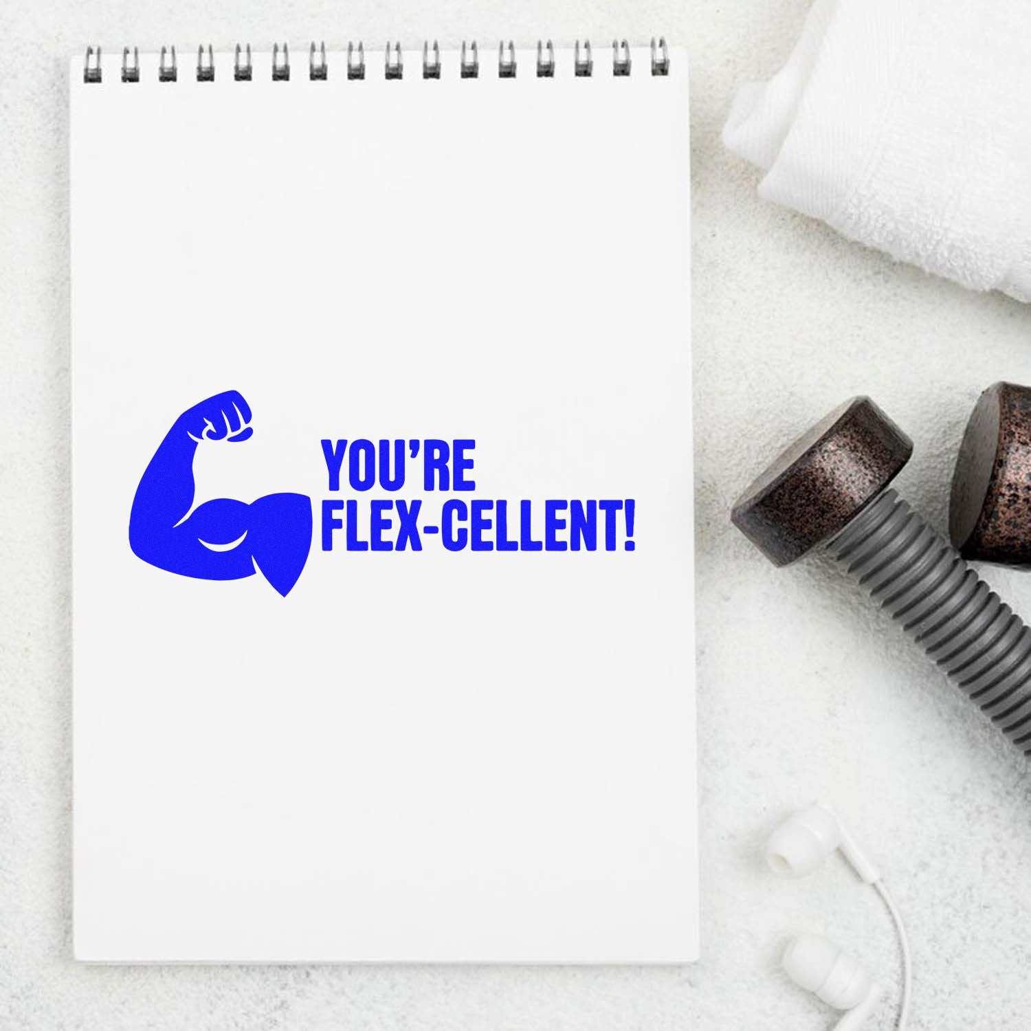 Fitness rubber stamp design with flexing arm and Youre flex-cellent! motivational message on notebook.