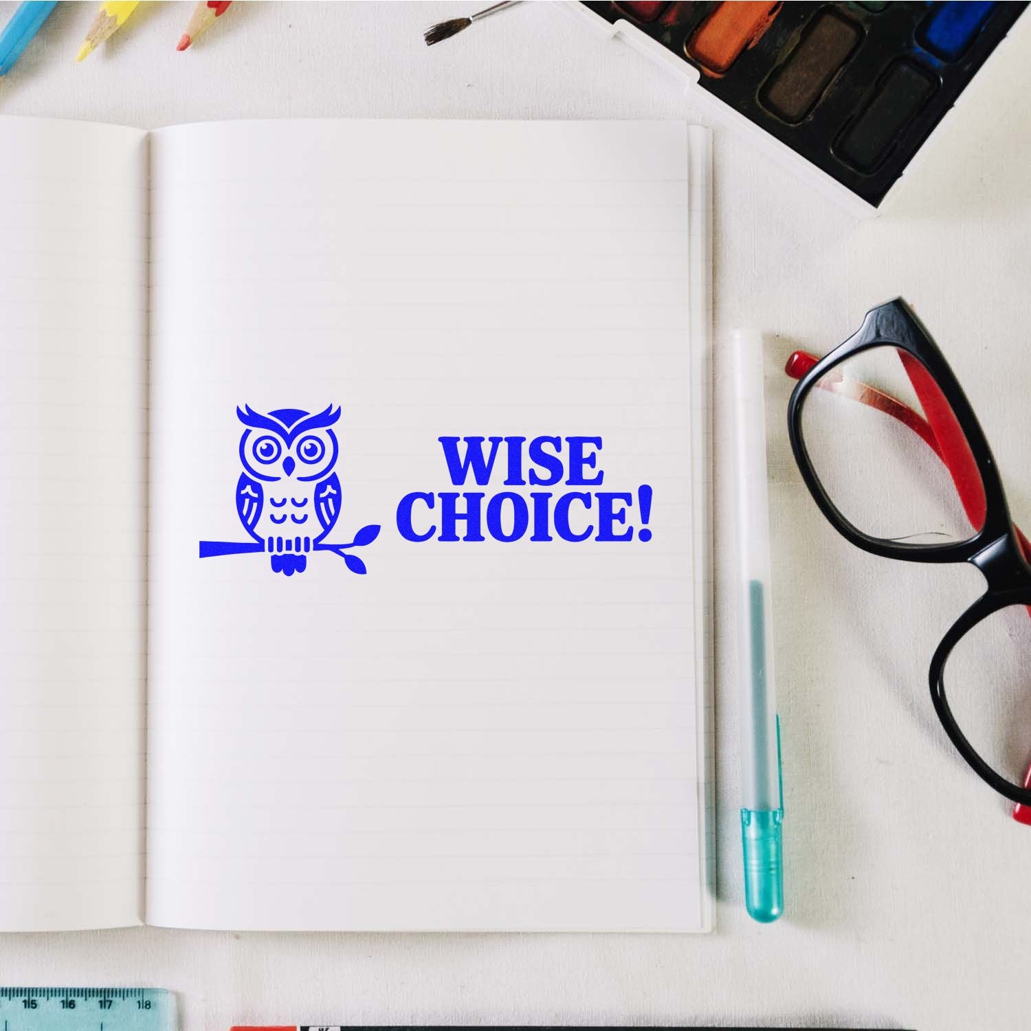 Wise Choice owl rubber stamp impression on notebook page, featuring a custom blue stationery stamp design.
