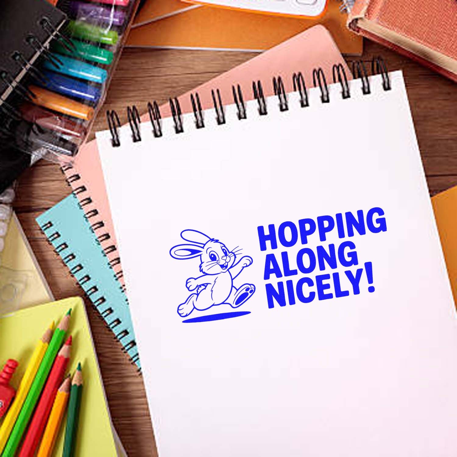 Hopping Along Nicely! bunny rubber stamp on notebook, perfect for teacher reward, classroom, and craft stamping.