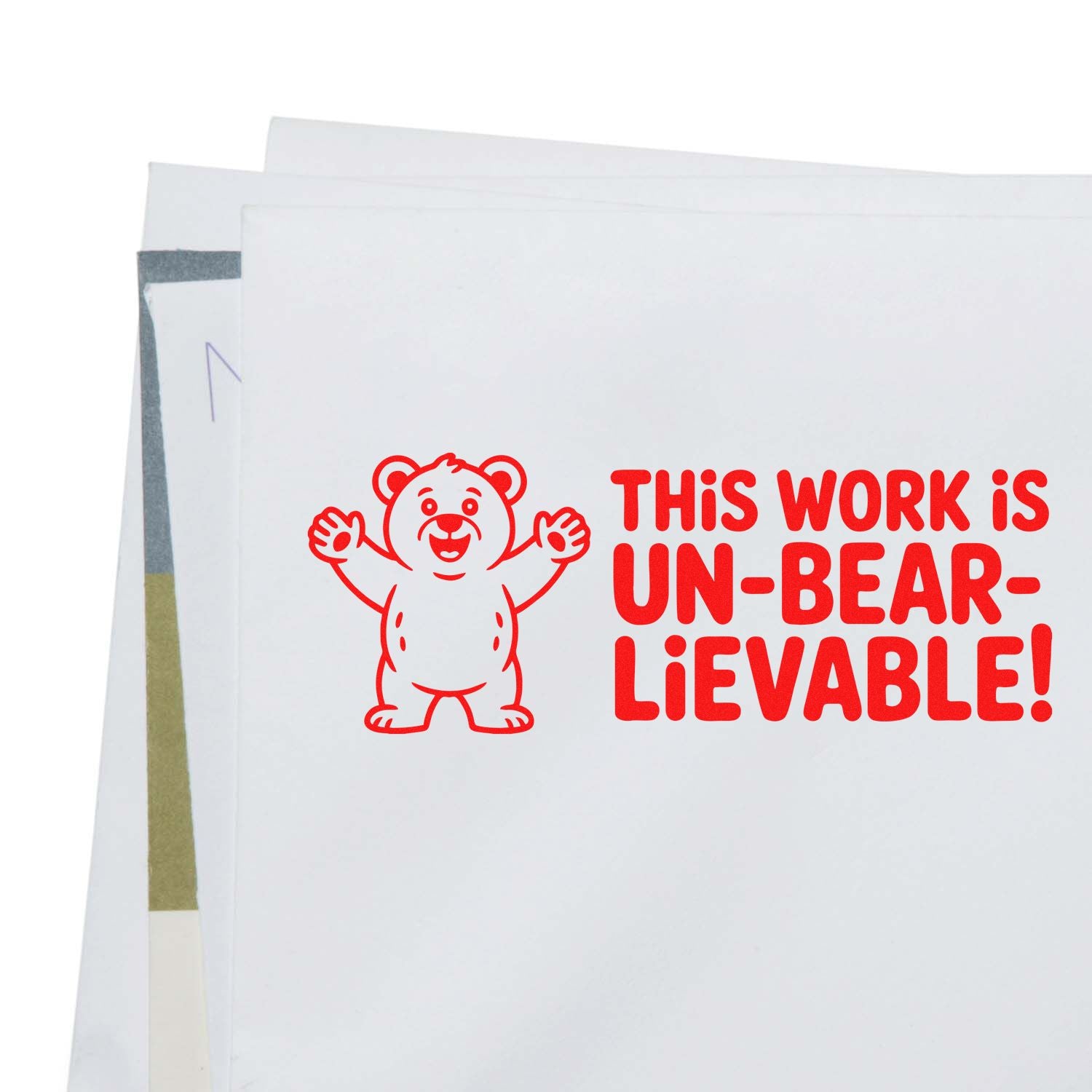 Funny bear rubber stamp imprint reading This work is un-bear-lievable! on a white envelope.