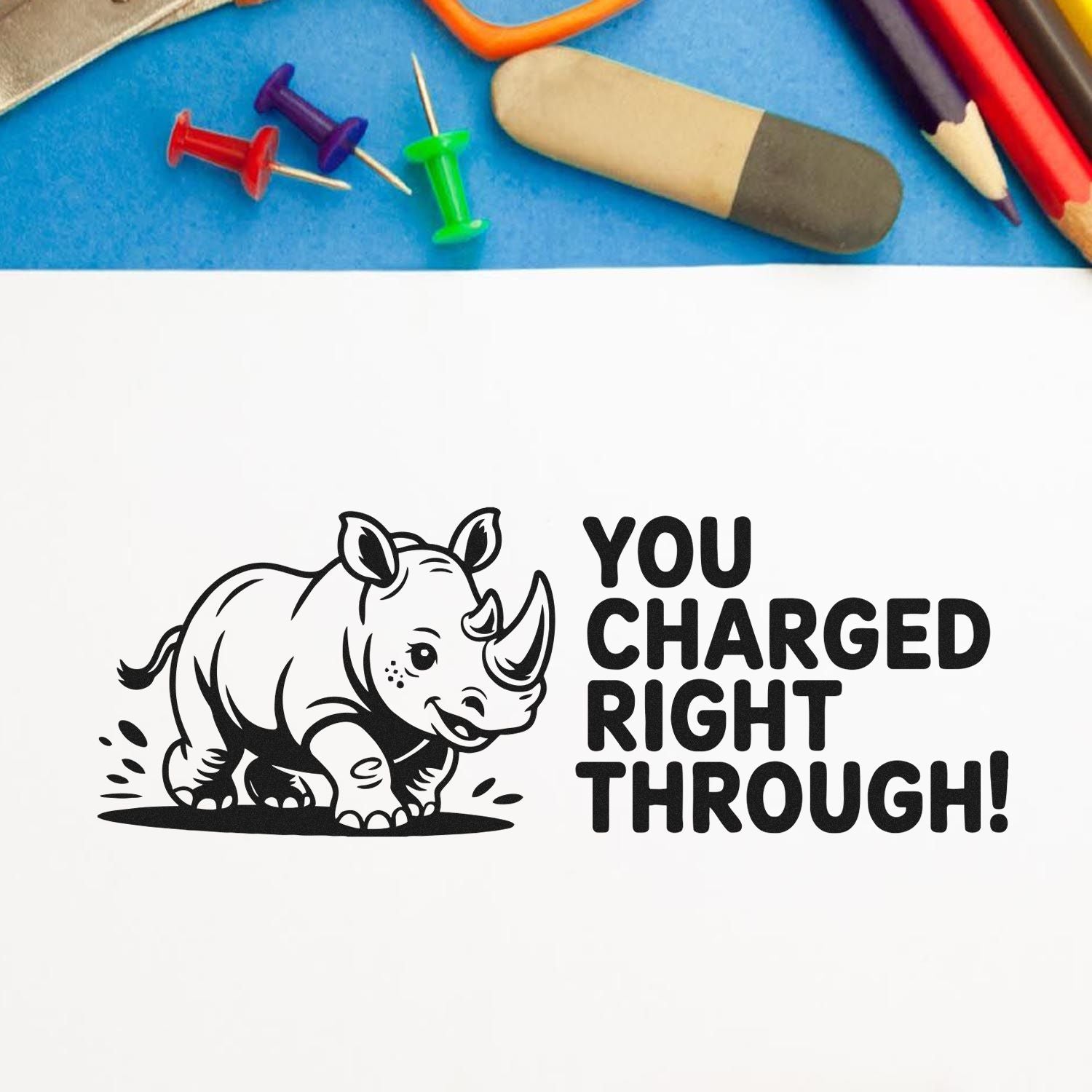 Funny rhinoceros rubber stamp design with You Charged Right Through! for encouragement, office notes, or school rewards.