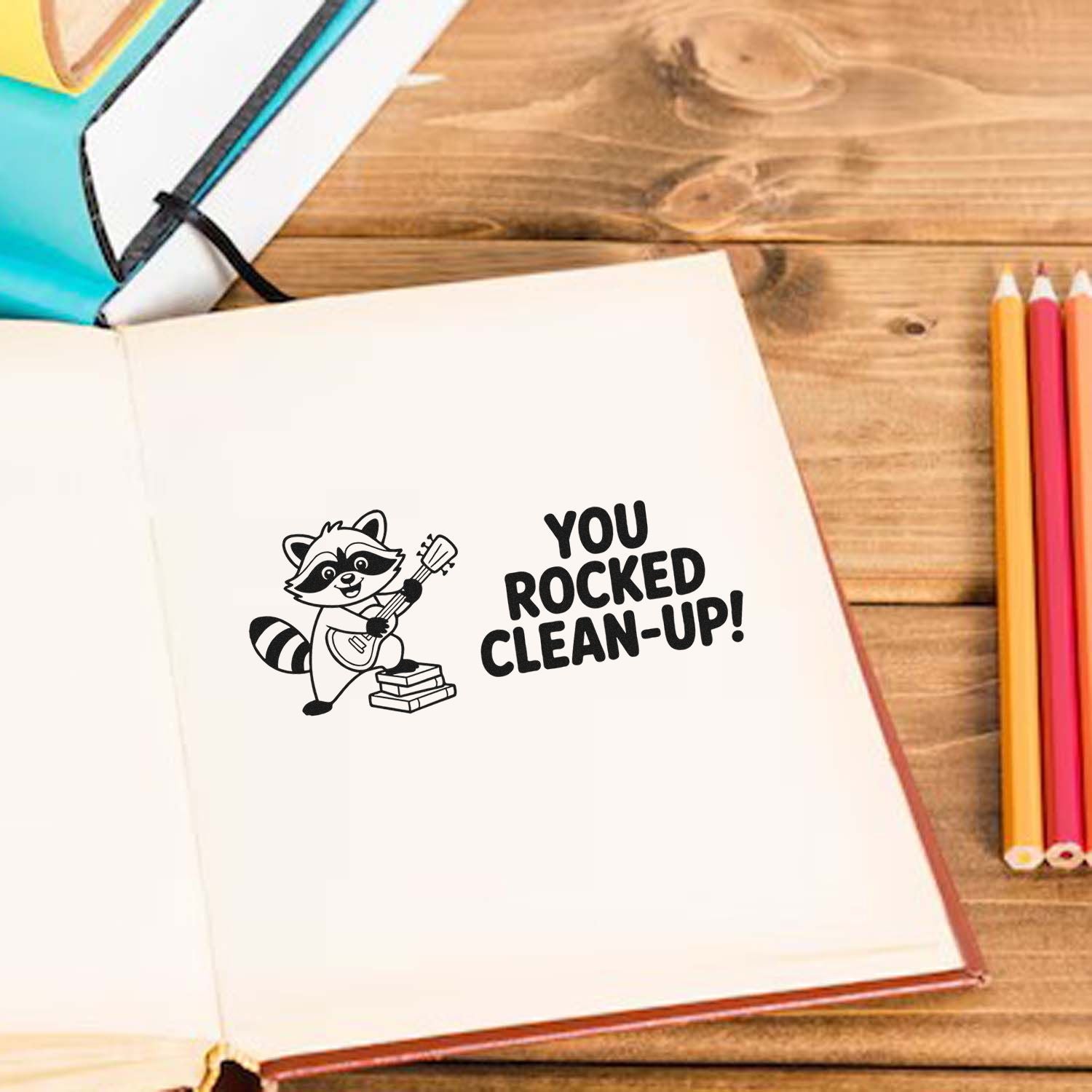 Clean-up thank you rubber stamp with raccoon guitarist and You Rocked Clean-Up! message in a journal.