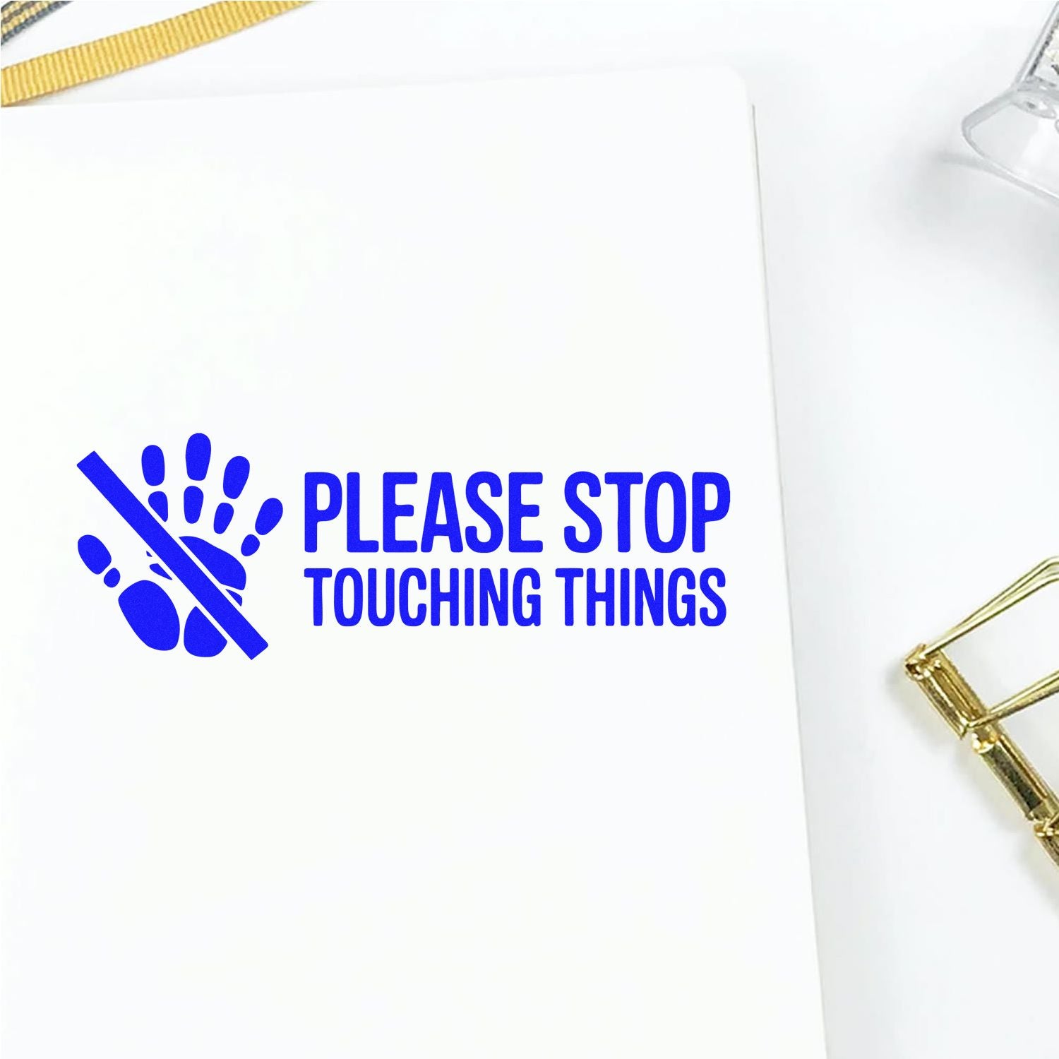 Blue custom rubber stamp reading Please Stop Touching Things with crossed-out hand icon for no-touch warning.
