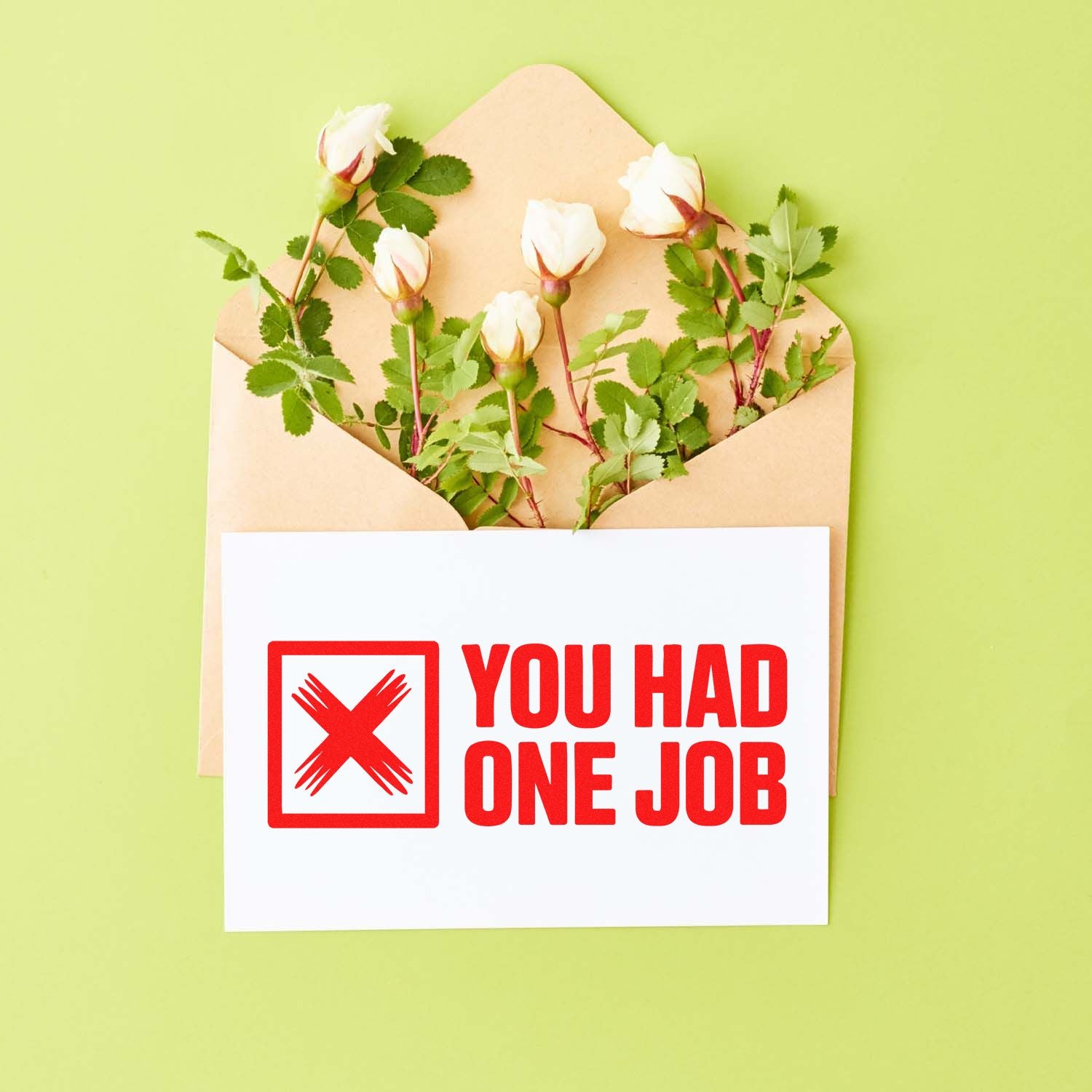 Humorous rubber stamp-style design with red YOU HAD ONE JOB text on a card over an envelope with flowers.