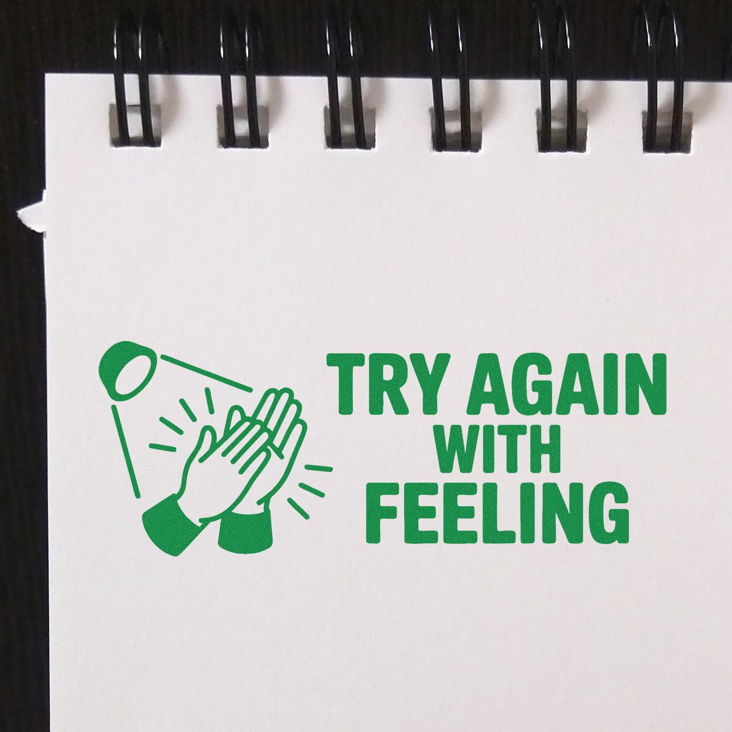 Rubber stamp design with clapping hands and text Try Again With Feeling for playful feedback.