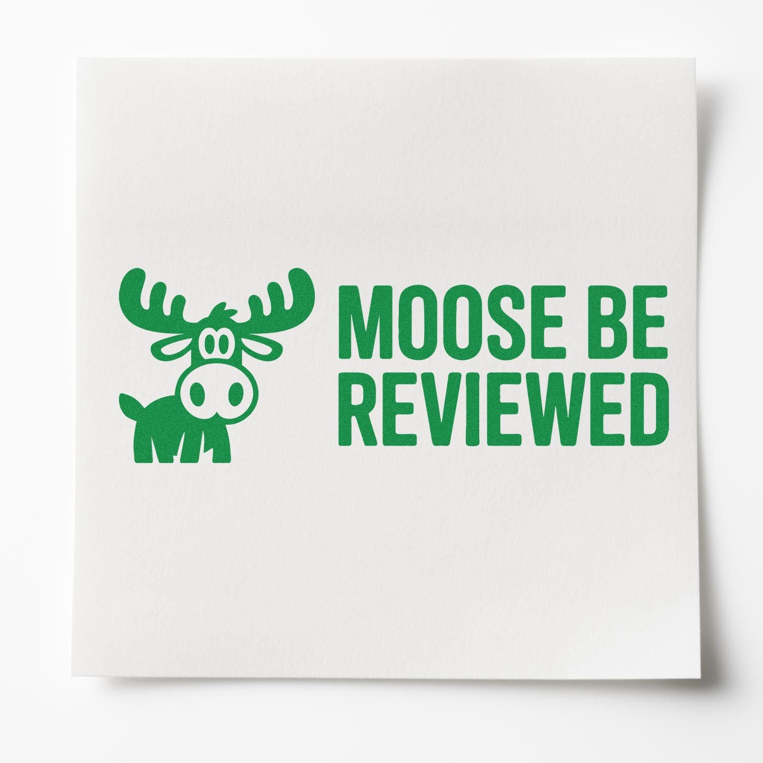 Humorous moose be reviewed rubber stamp with cartoon moose and bold green lettering.