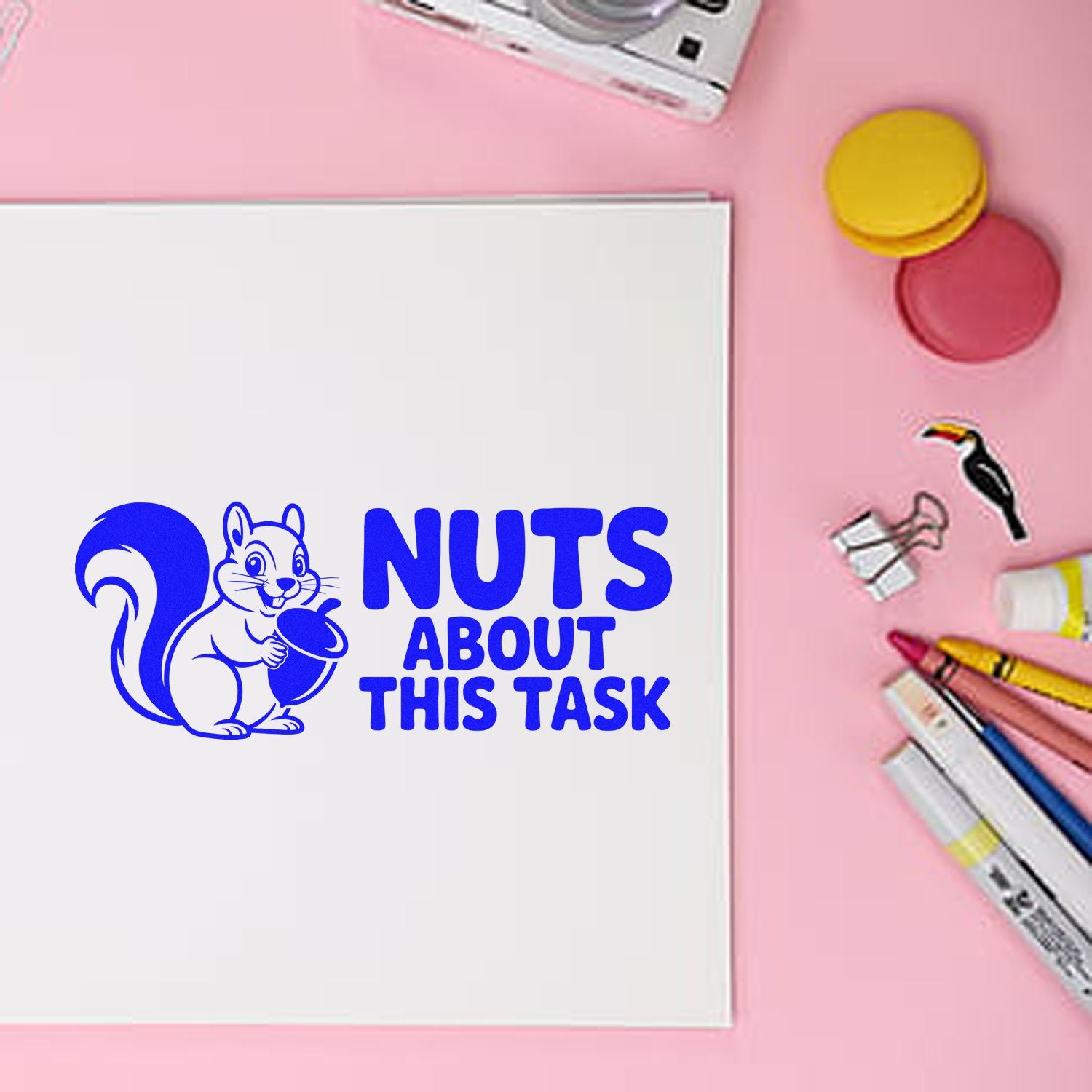 Nuts about this task squirrel rubber stamp for planners, shown on a notebook with stationery on a pink background.