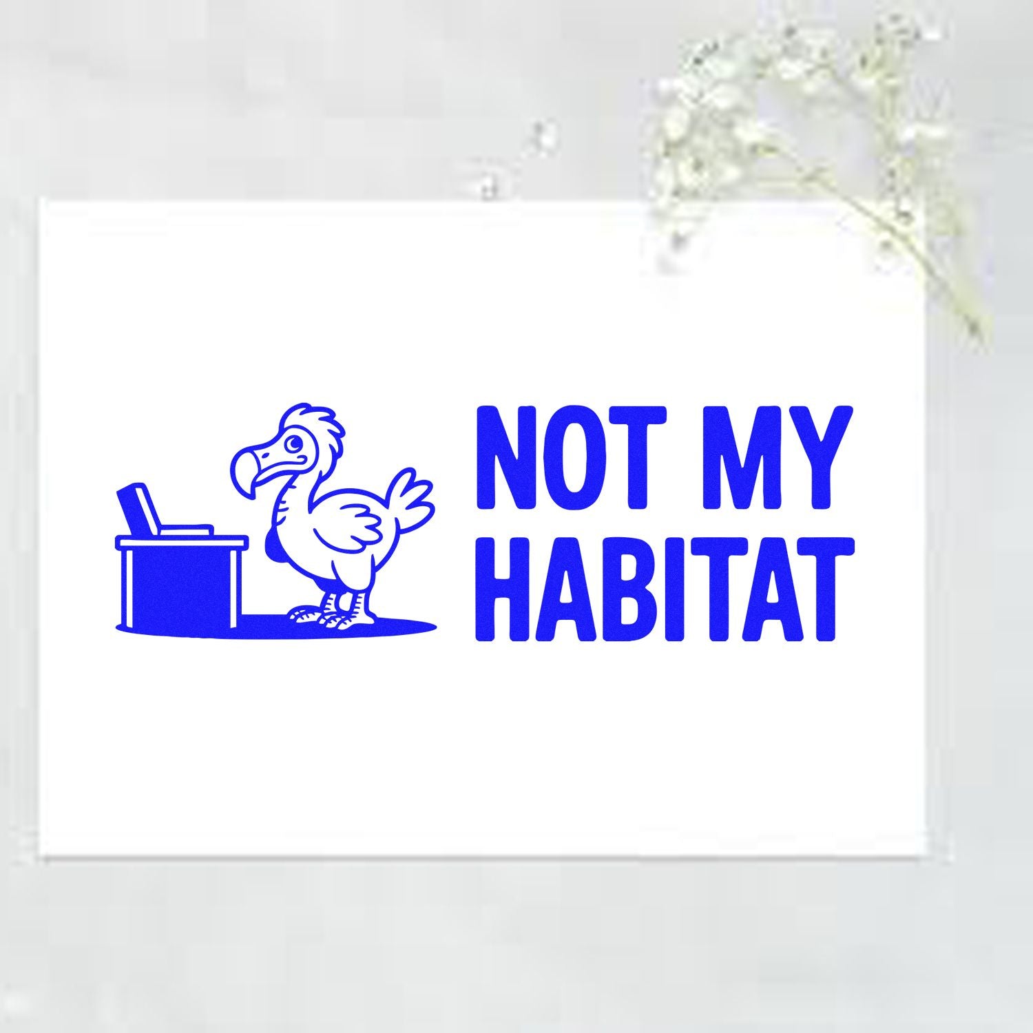 Humorous rubber stamp reading Not My Habitat with a dodo bird and desk icon, a funny office-style design for crafts and stationery.