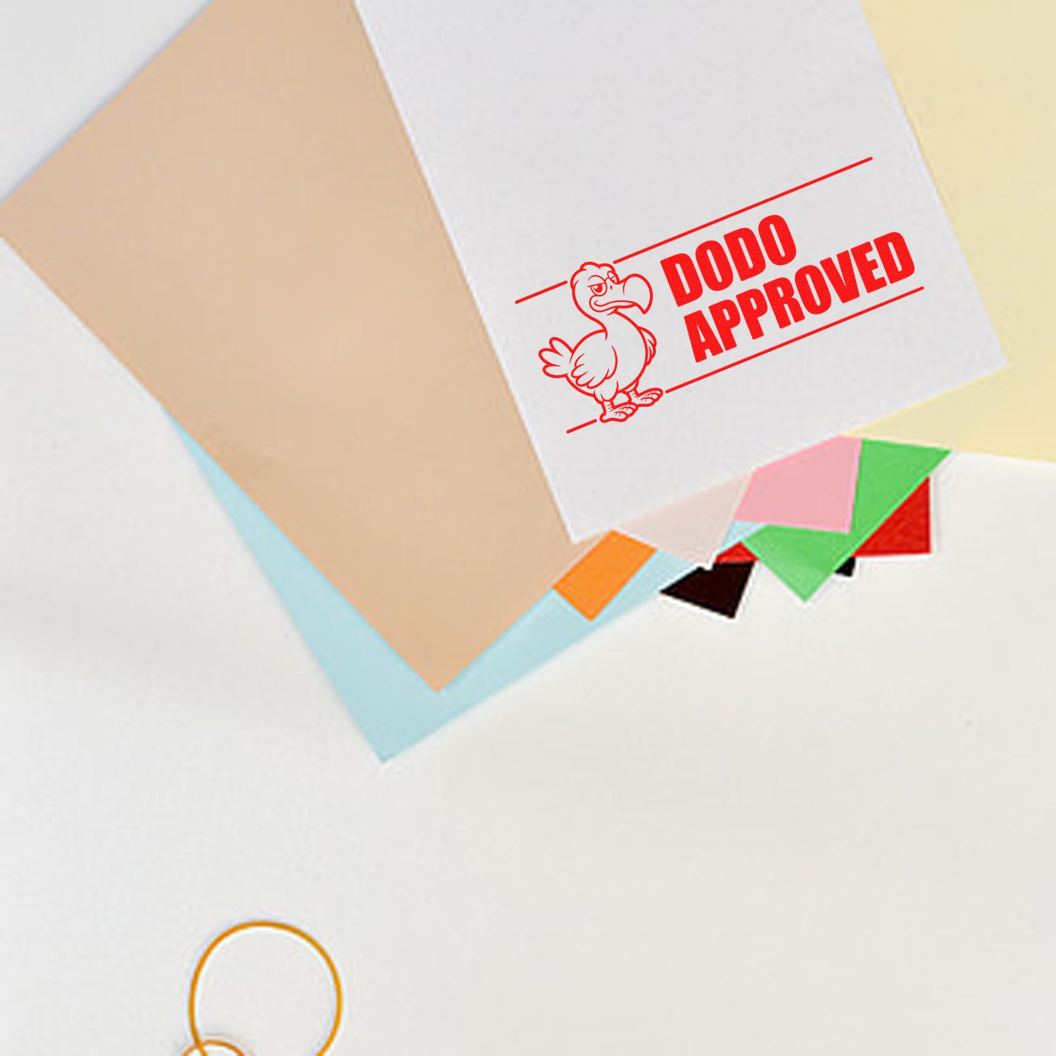 Red DODO Approved rubber stamp imprint on paper for custom office approval and branding.