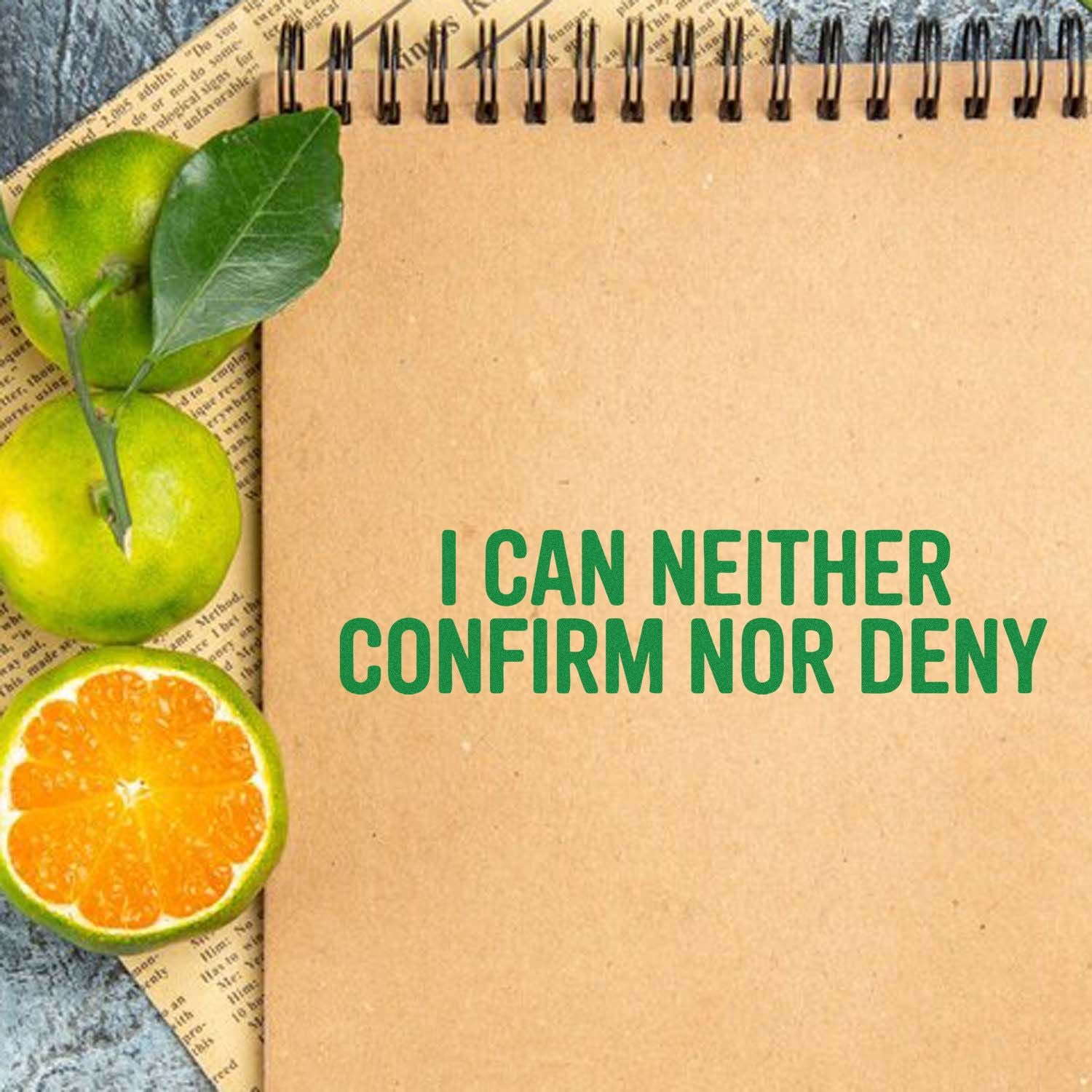 Funny rubber stamp design reading I Can Neither Confirm Nor Deny on a kraft notebook, styled with citrus fruit accents.