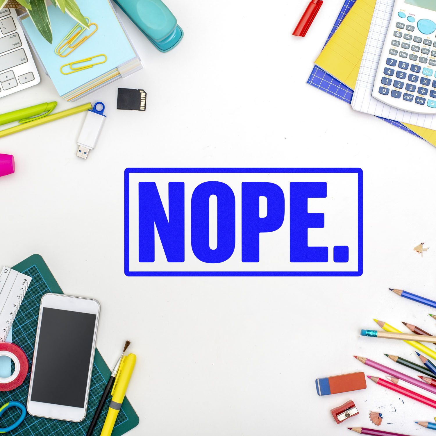 Blue NOPE rubber stamp graphic on a white desk with office supplies, perfect for rejection or approval stamp designs.