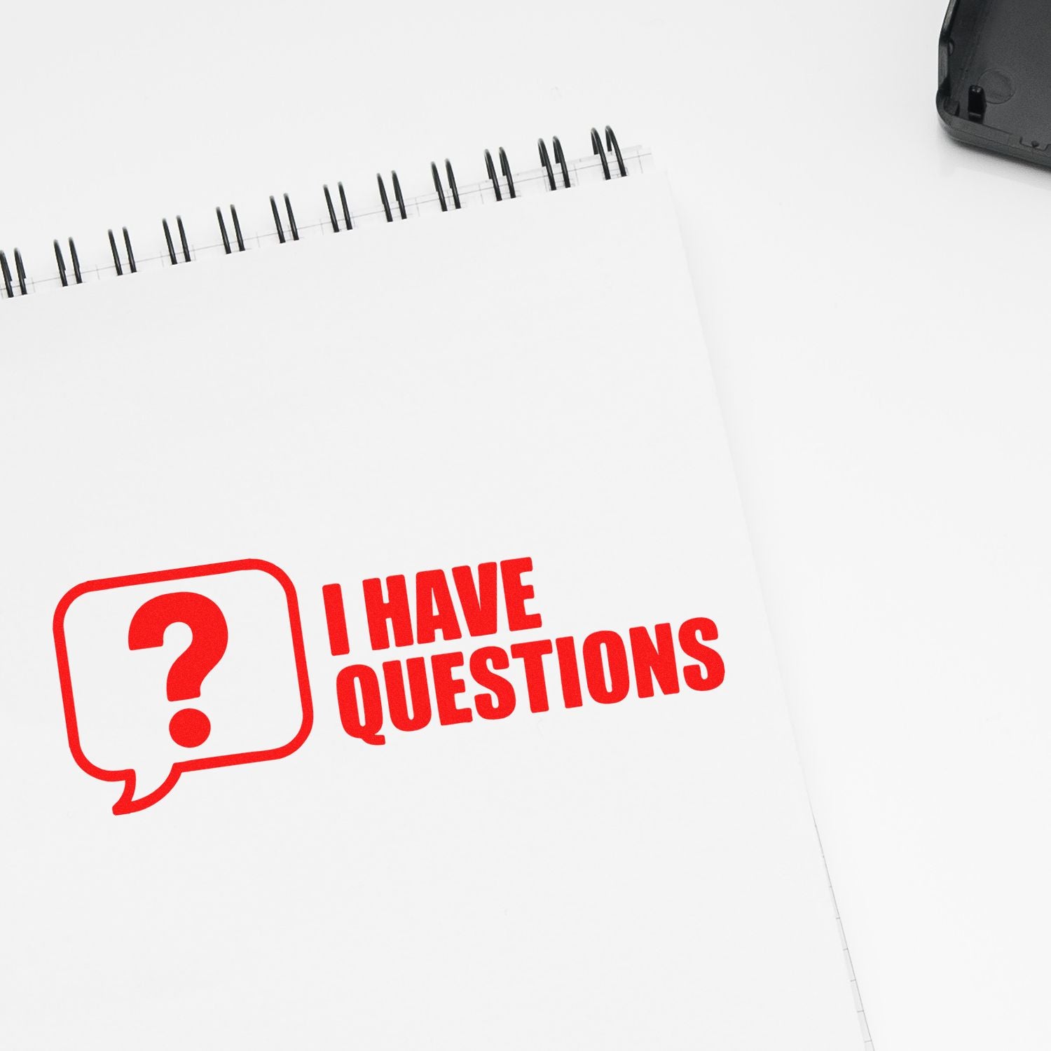Rubber stamp imprint reading I Have Questions on a notebook page, ideal for office forms, feedback, and classroom use.