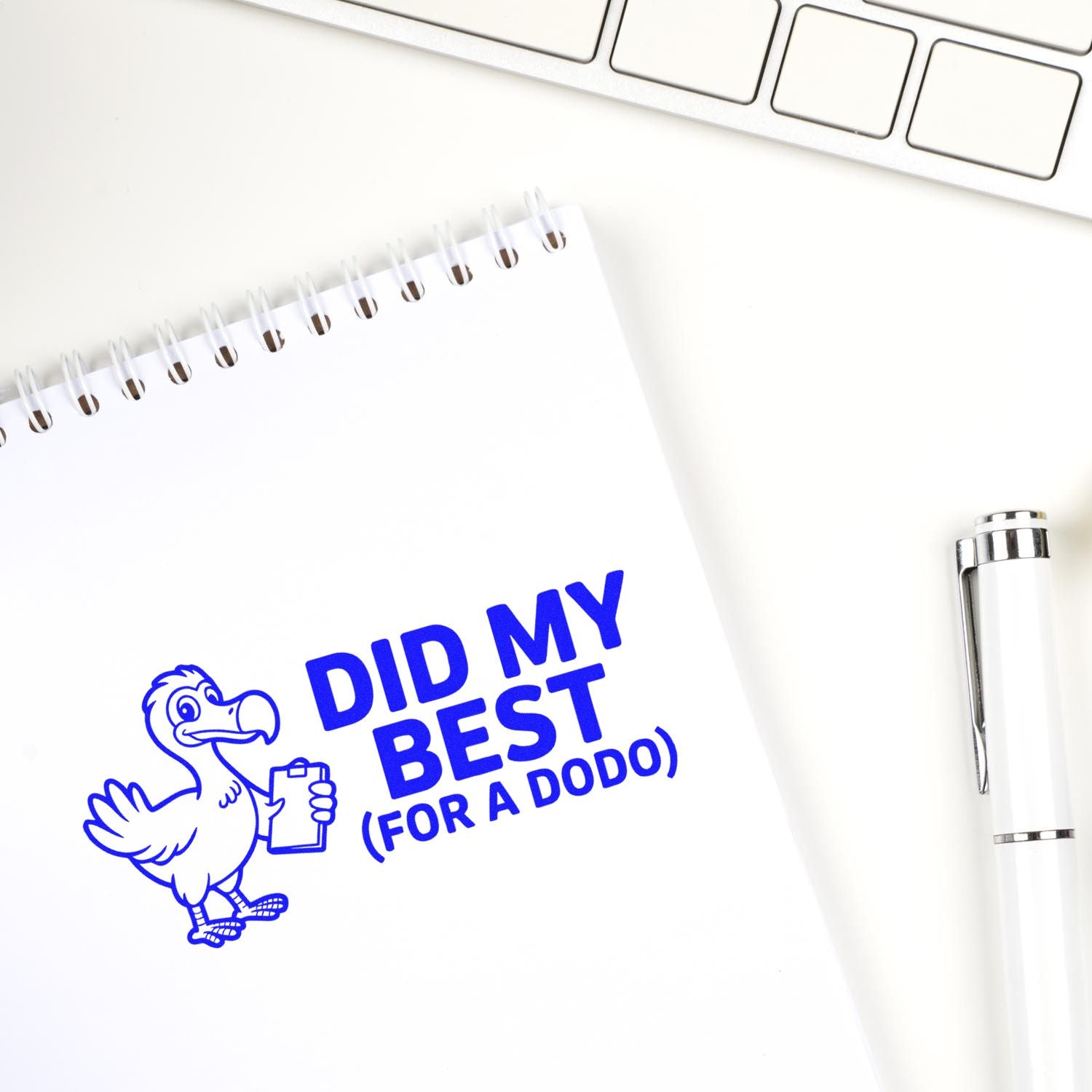 Blue custom rubber stamp reading Did My Best (For a Dodo) with cartoon bird on notebook, ideal for office humor stamps.