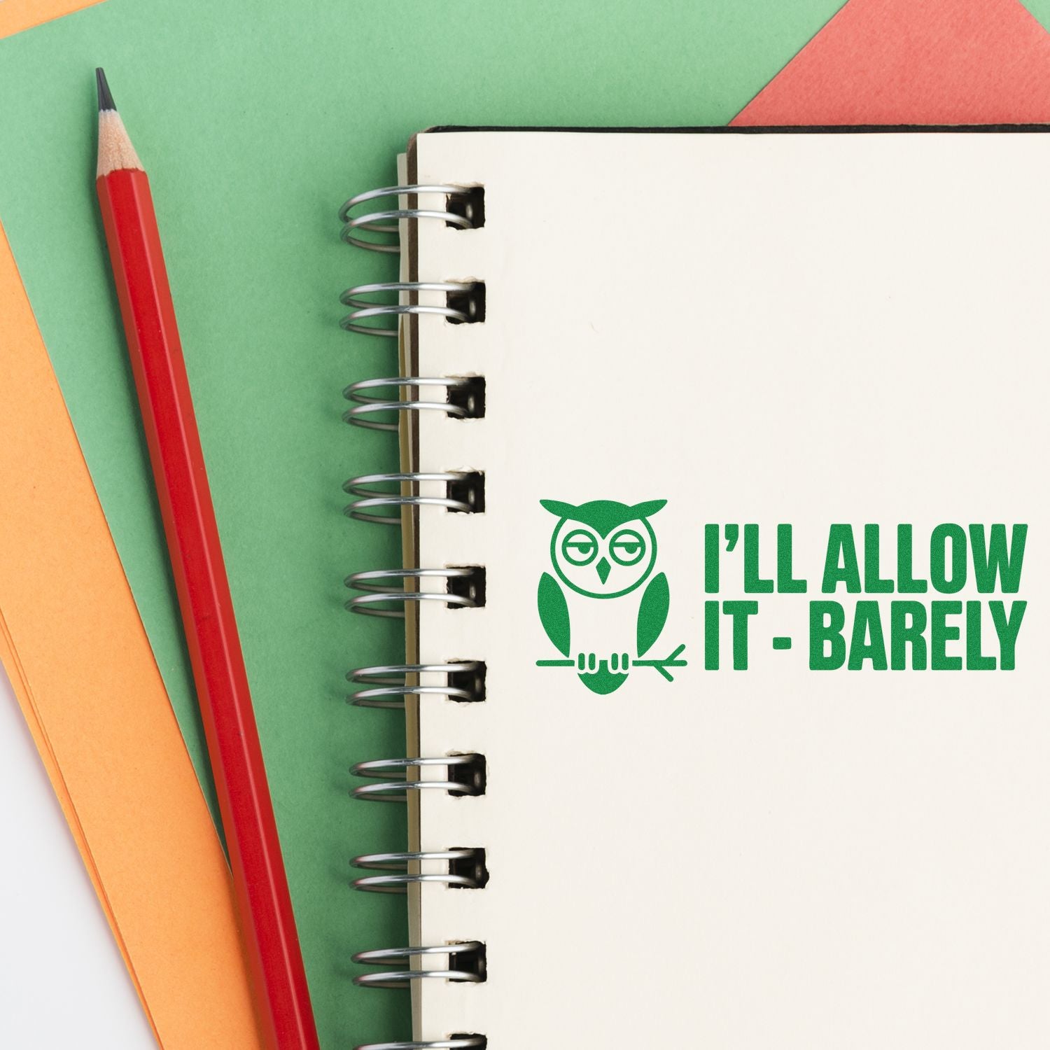 Custom rubber stamp design with owl and Ill Allow It - Barely text on a notebook page beside pencils.