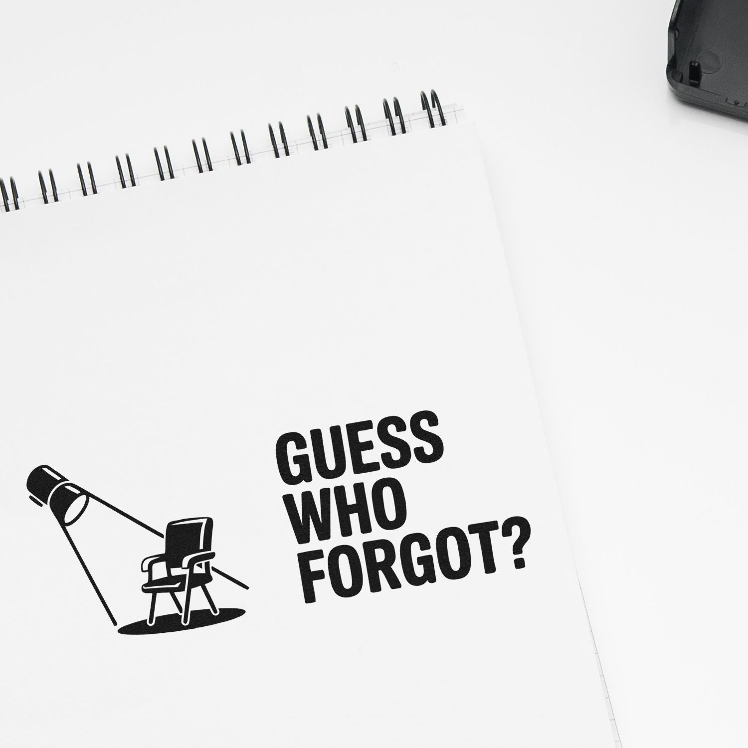 Custom rubber stamp mockup reading Guess Who Forgot? with lamp and chair illustration for office supplies.