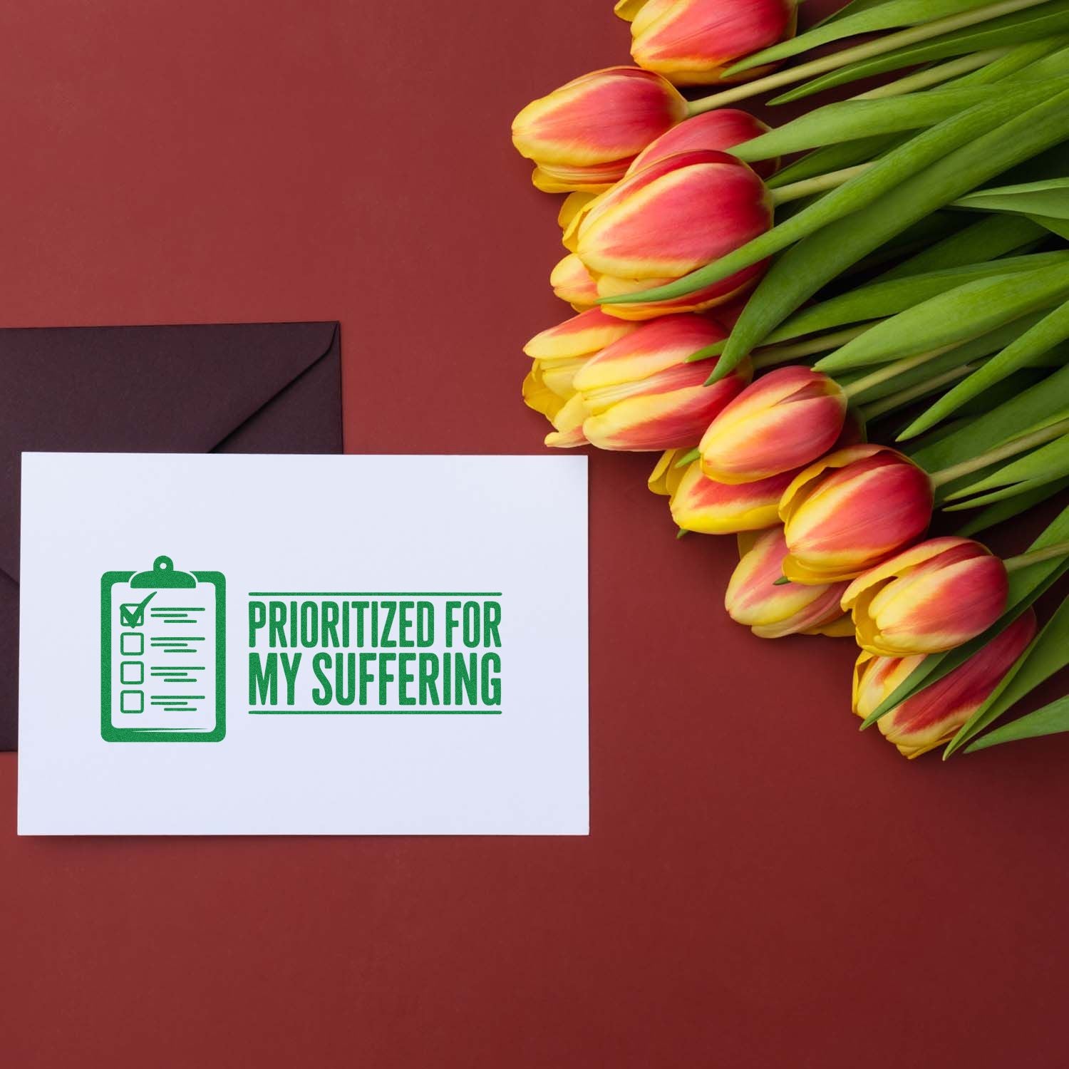 Funny rubber stamp design reading Prioritized for My Suffering on a greeting card with tulips and envelope.