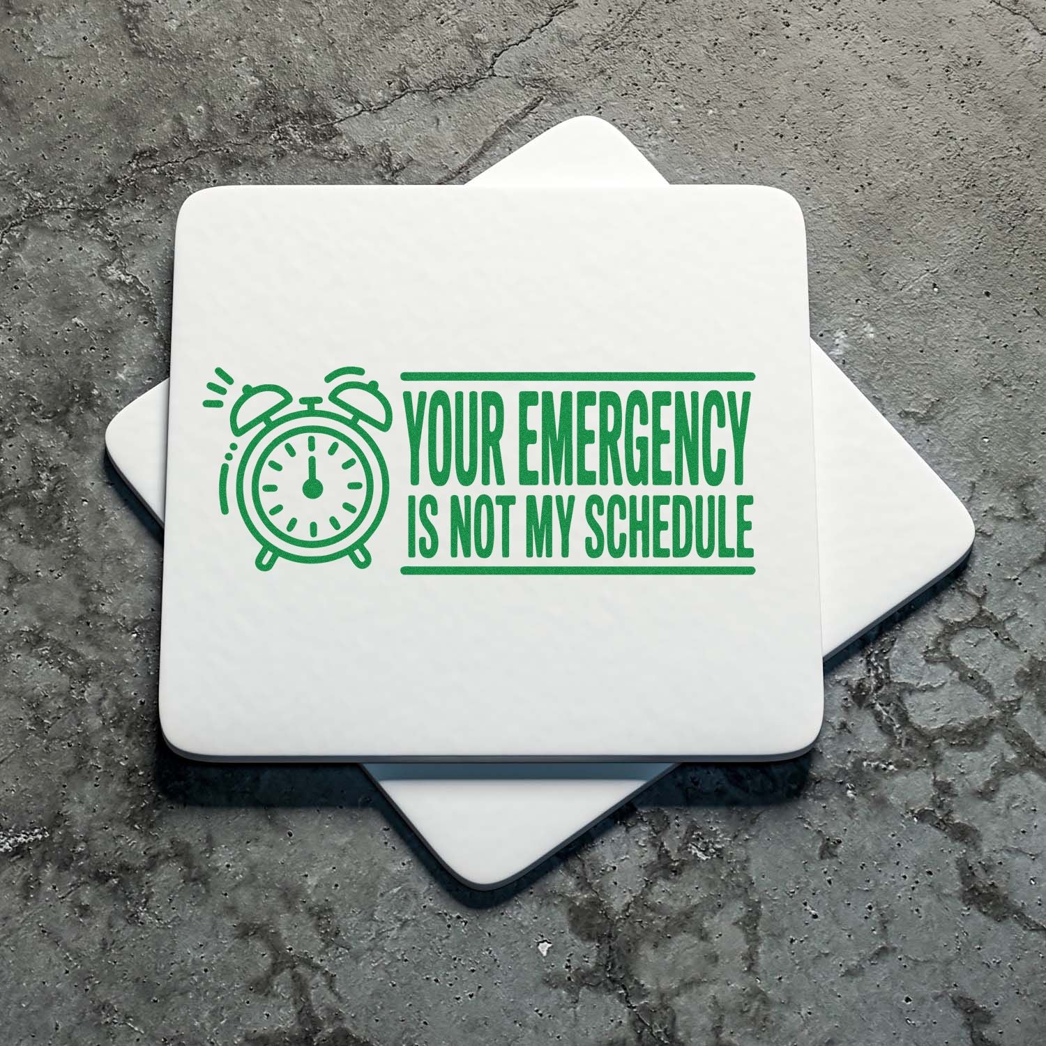 Green rubber stamp design with alarm clock icon and Your Emergency Is Not My Schedule office humor text.