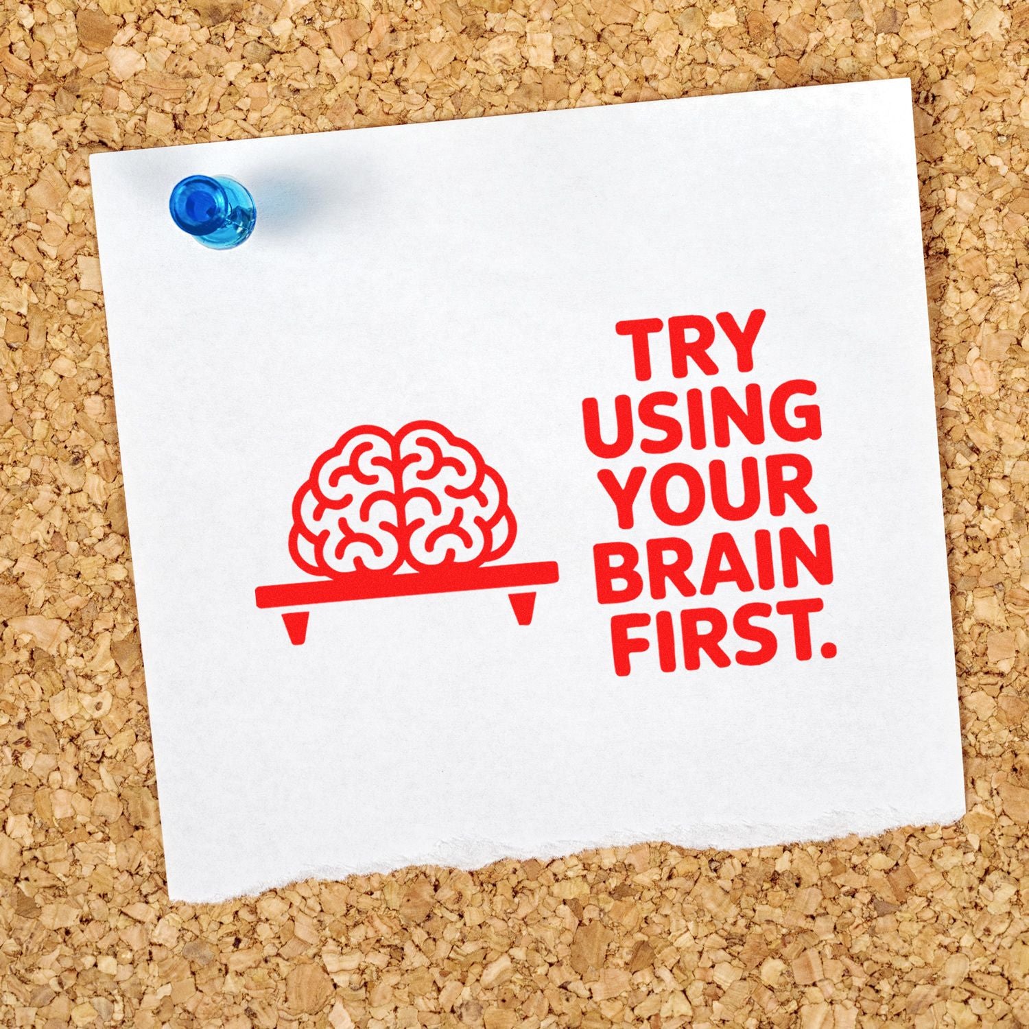 Red motivational rubber stamp reading Try using your brain first with brain icon pinned on a cork board.