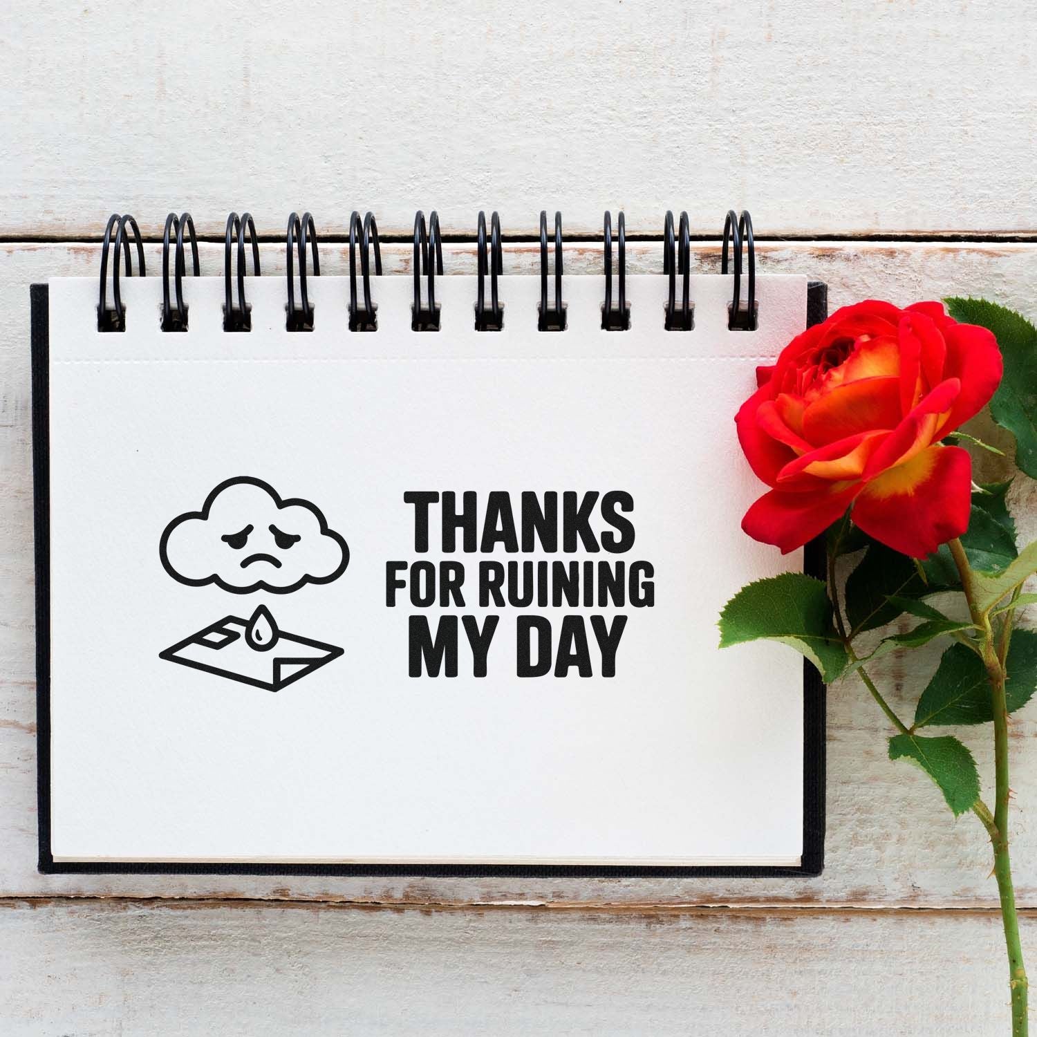 Sarcastic rubber stamp design reading Thanks for Ruining My Day with sad cloud and envelope icon in a notebook.