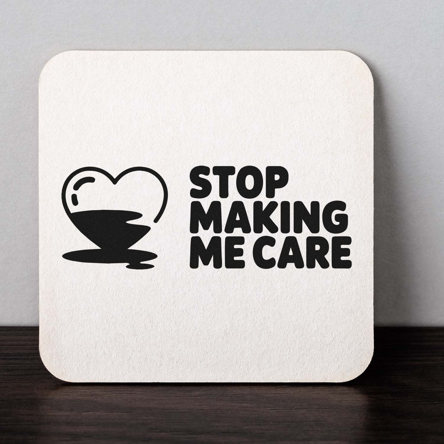 Custom rubber stamp with heart and bold Stop Making Me Care text, ideal for sarcastic craft projects and stationery.