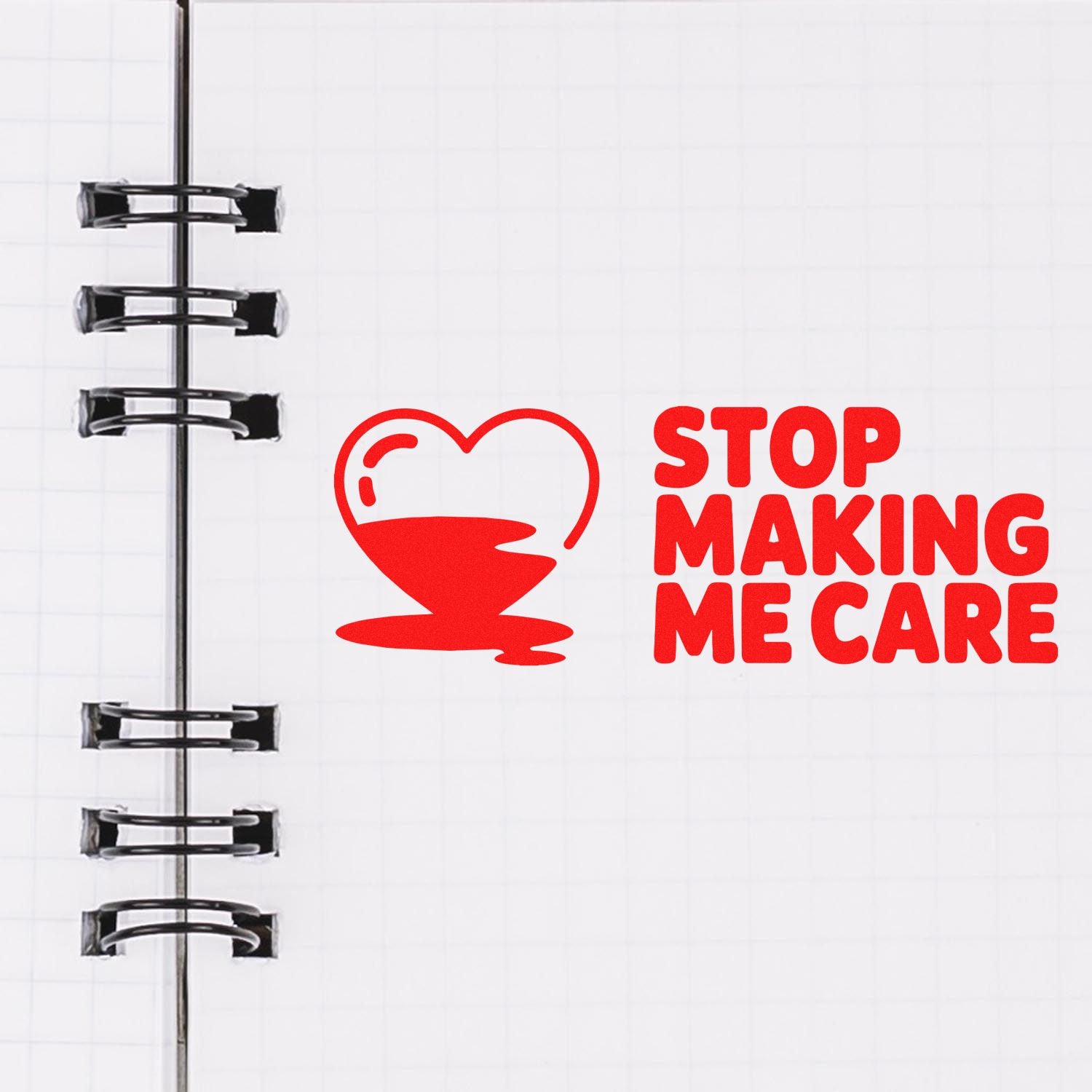 Custom rubber stamp design with heart icon and Stop Making Me Care quote on notebook paper.