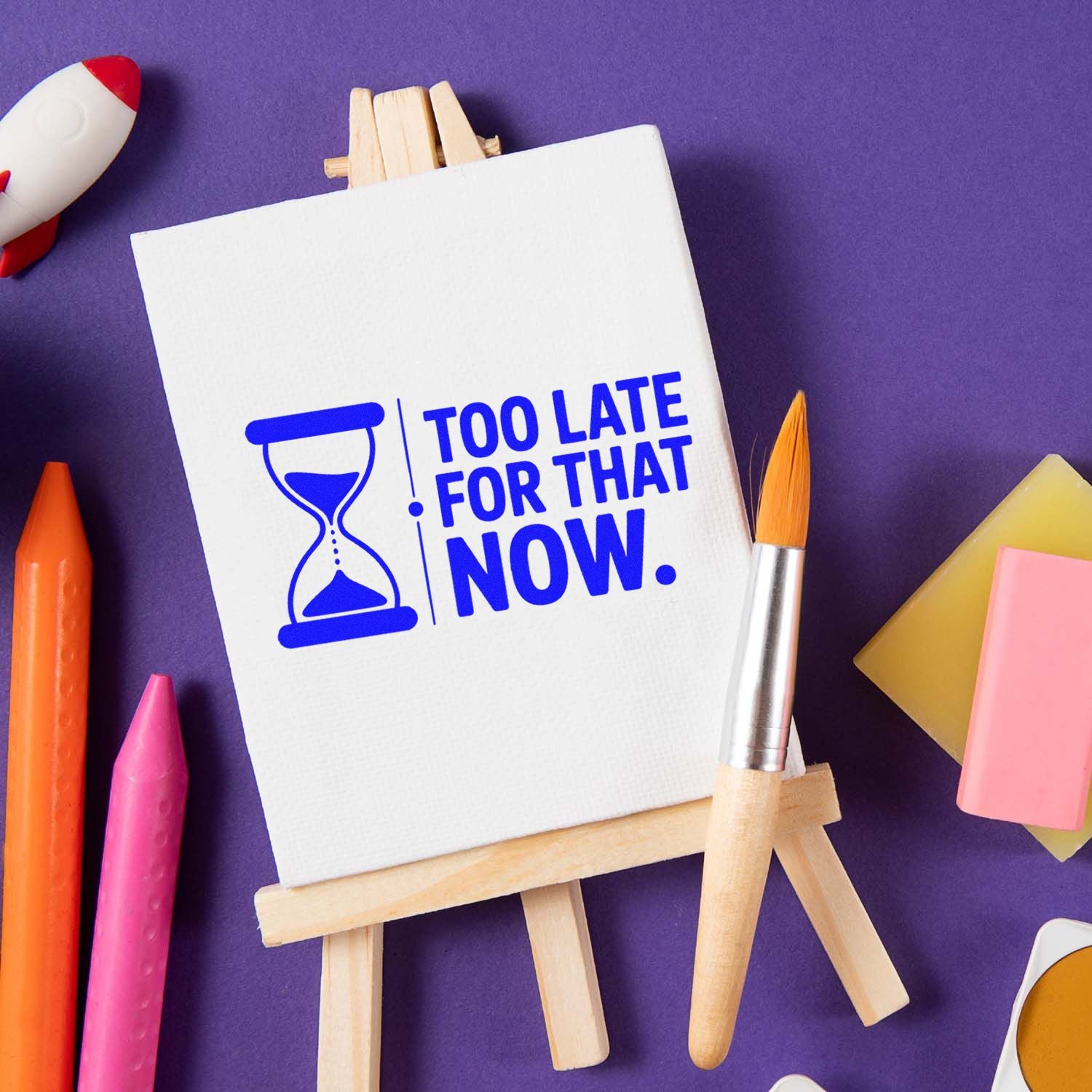 Custom rubber stamp design with hourglass and Too Late for That Now text on easel, ideal for office and craft use.