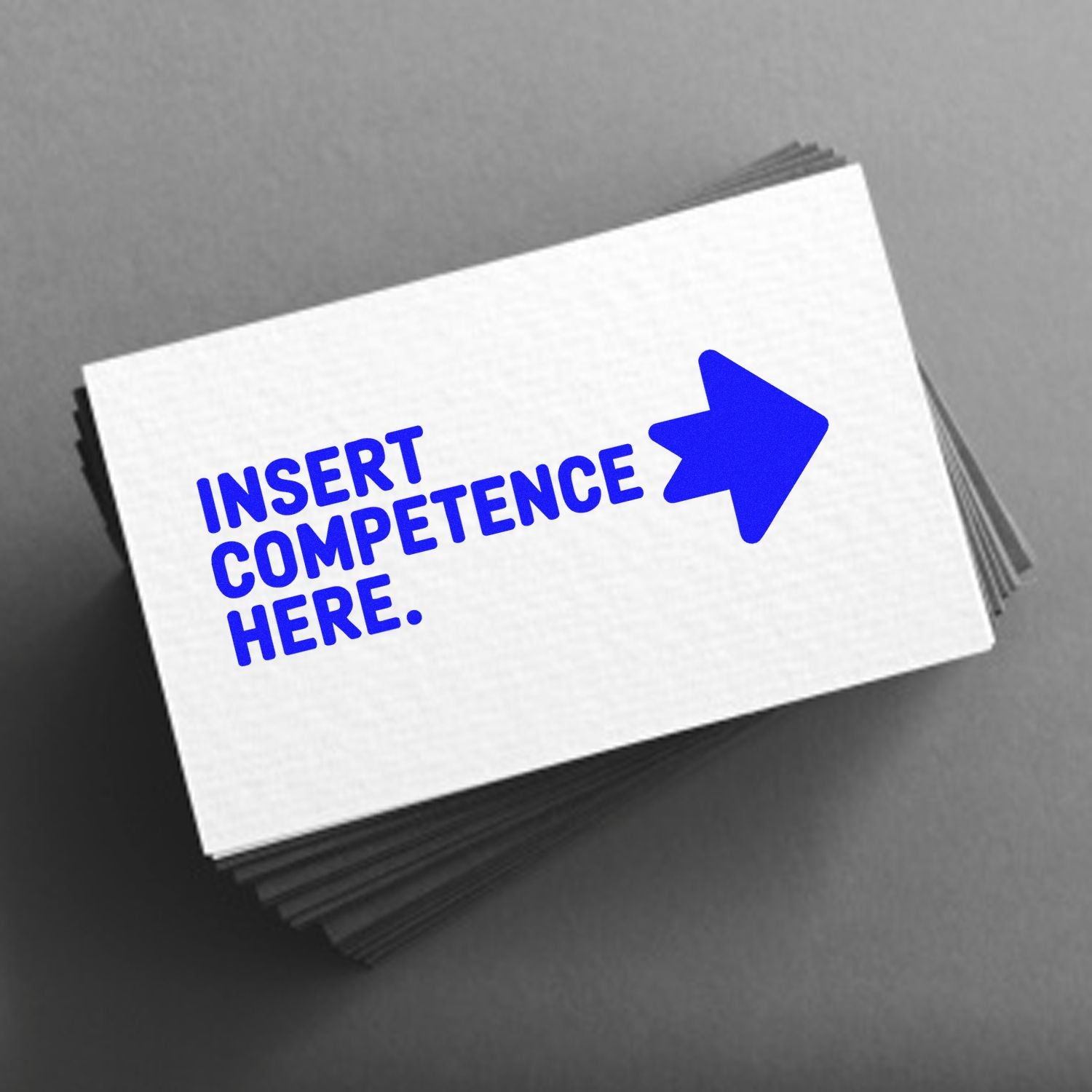 Custom rubber stamp mockup with Insert Competence Here text and arrow on stacked business cards.