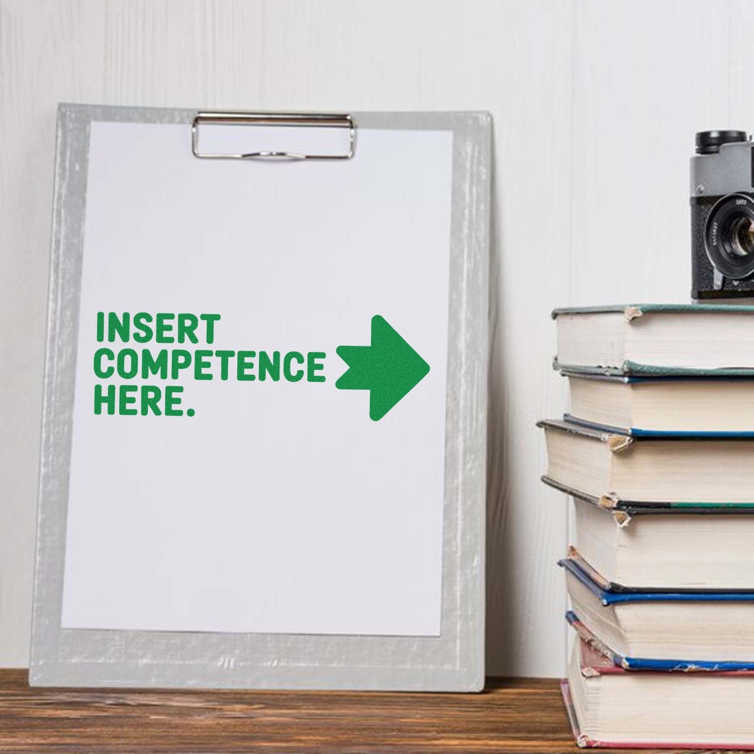 Custom rubber stamp concept with Insert Competence Here on clipboard, ideal for office and teacher branding.