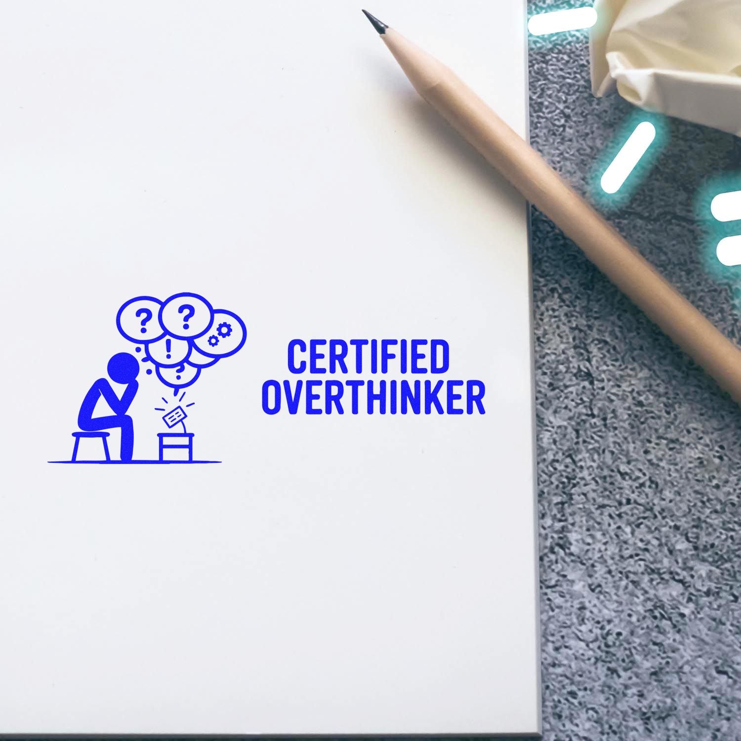 Certified Overthinker rubber stamp on notebook page with pencil, blue self-inking stamp design for stationery and gifts
