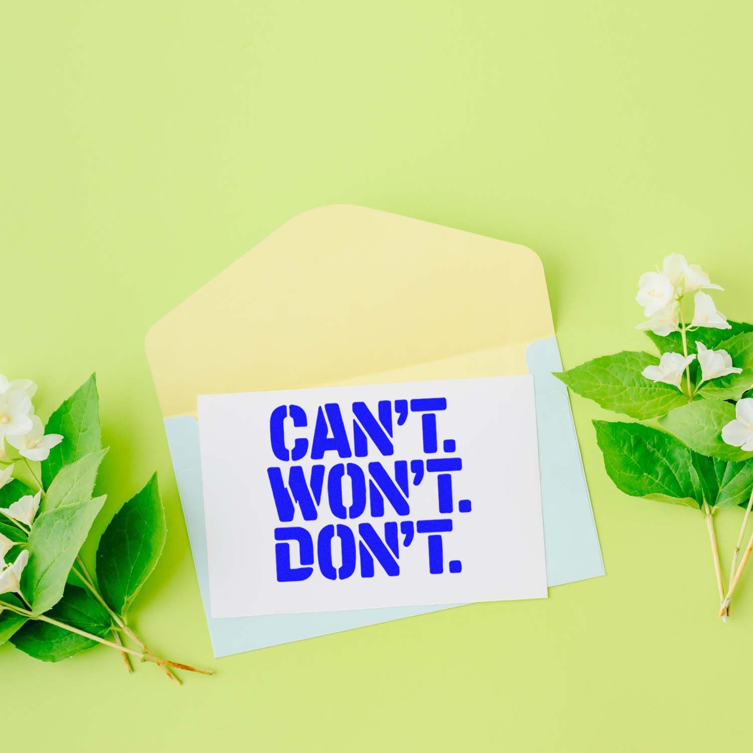 Cant, Wont, Dont rubber stamp design on envelope with flowers and pastel stationery on green background.