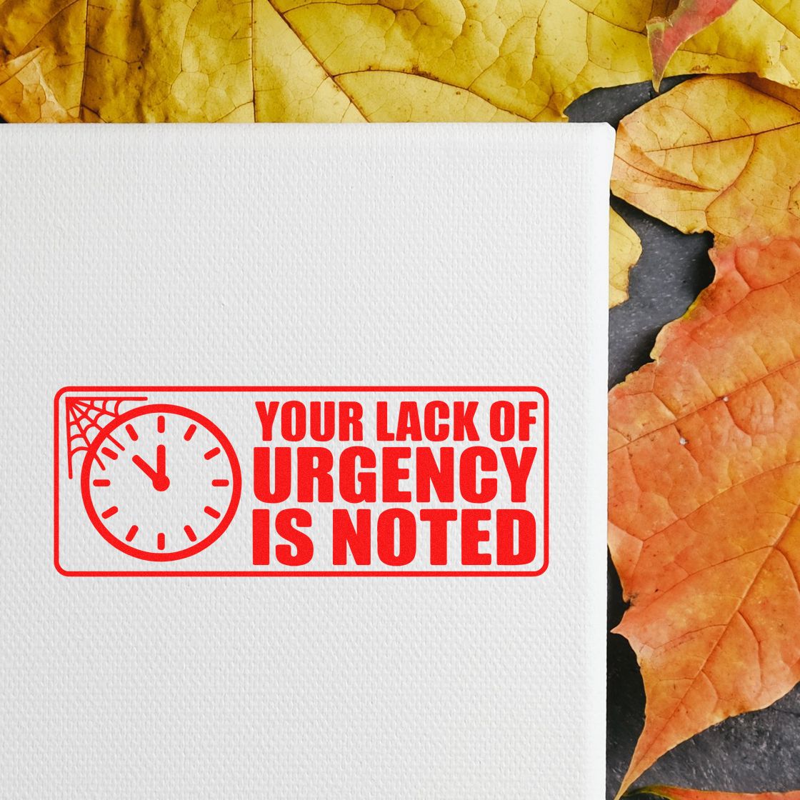 Humorous rubber stamp design reading Your Lack of Urgency Is Noted with clock icon on white paper, ideal for office approval and deadlines.